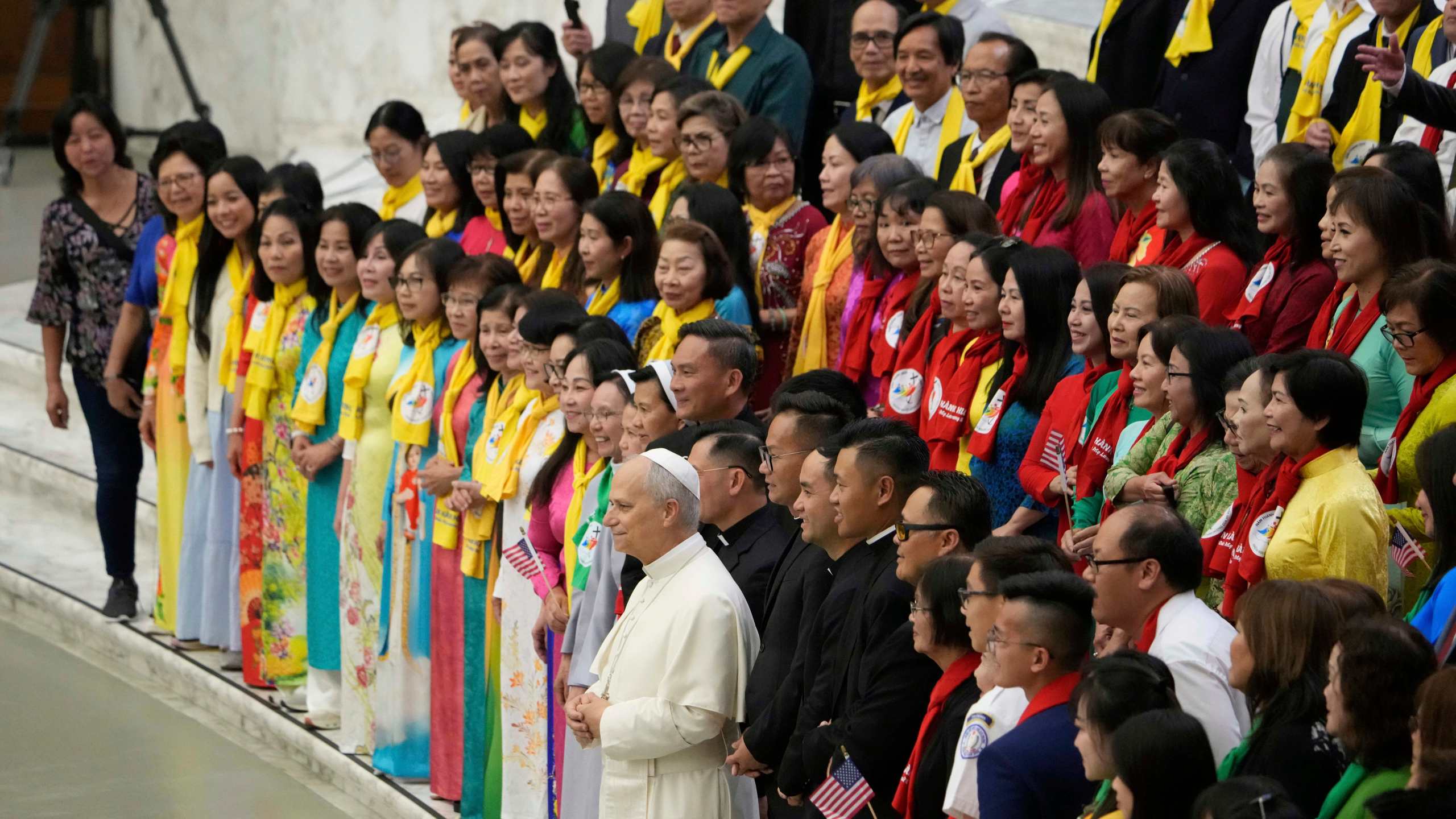 Pope Leo XIV, front center, poses with Vietnamese faithful during the weekly general audience at the Vatican, Wednesday, Aug. 27, 2025. (AP Photo/Gregorio Borgia)