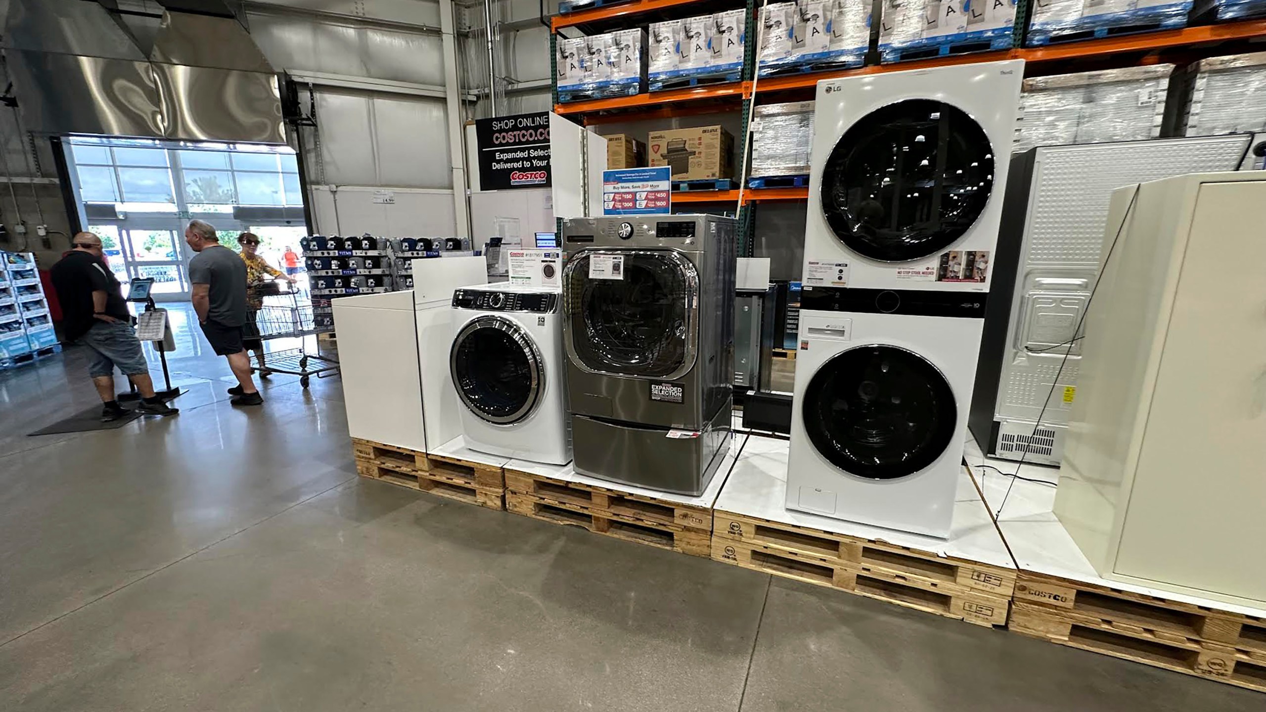 Washers stand on display near the entrance to a Costco warehouse Tuesday, July 8, 2025, in Sheridan, Colo. (AP Photo/David Zalubowski)