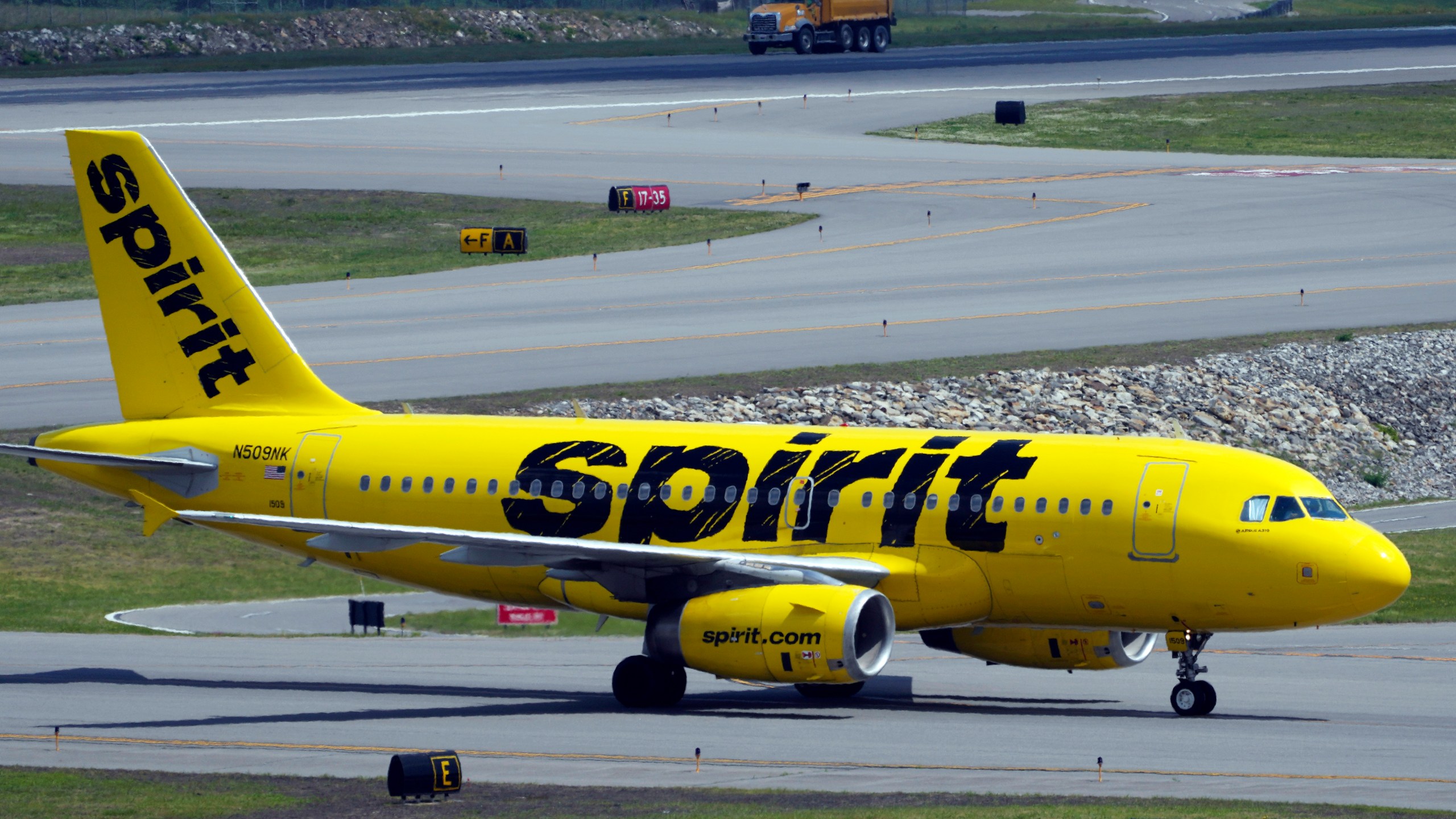 A Spirit Airlines 319 Airbus taxis at Manchester Boston Regional Airport.