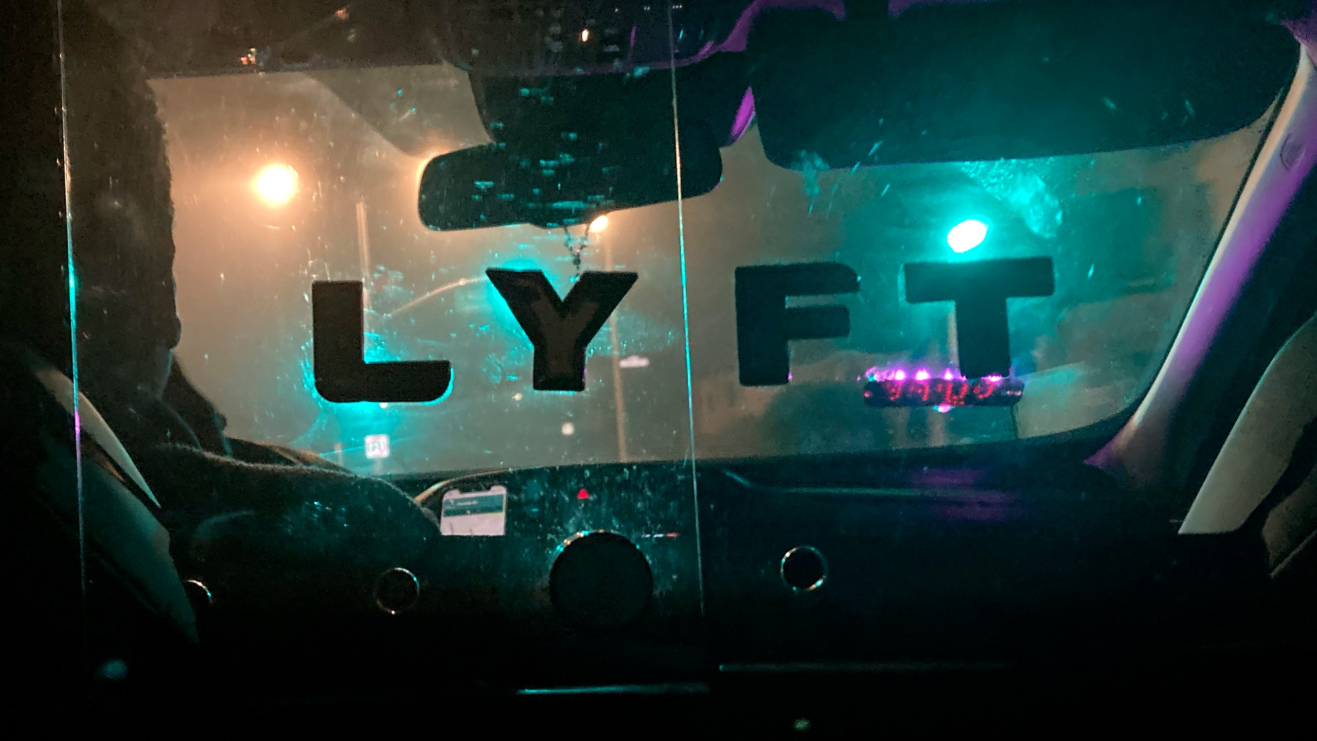 FILE - A Lyft sign is displayed in a driver's car in San Francisco, April 27, 2023. (AP Photo/Jeff Chiu, File)