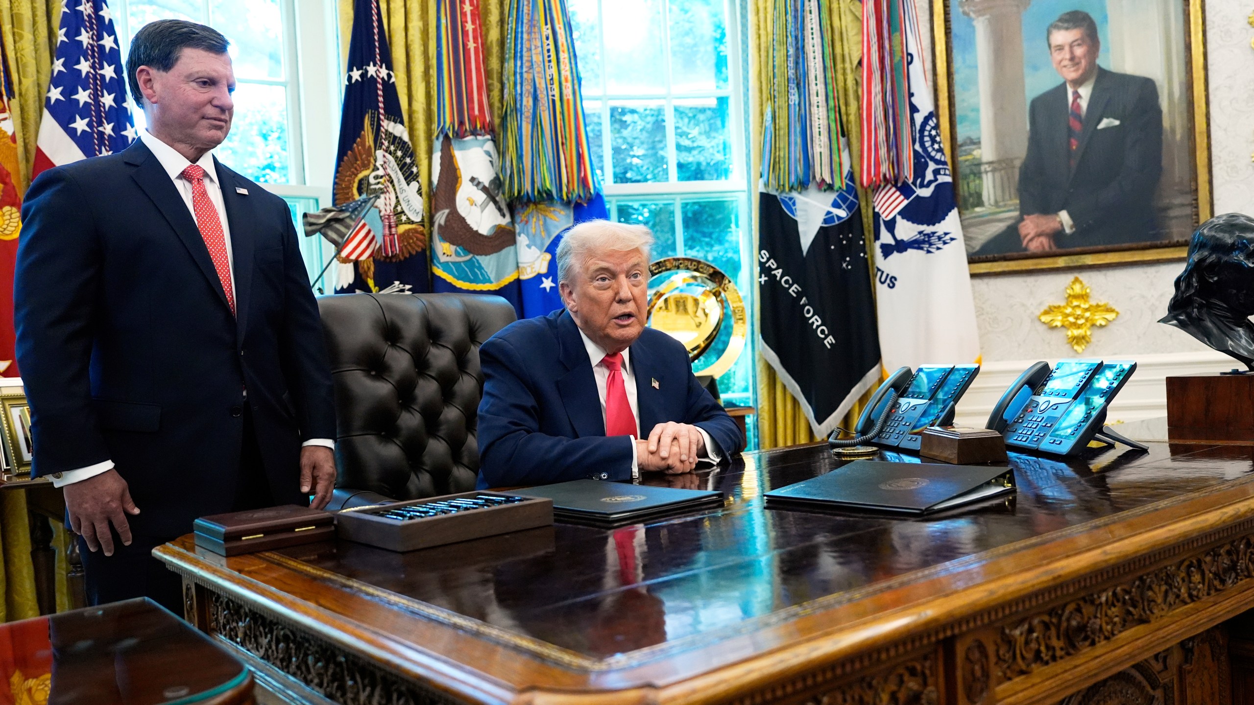 Social Security Commissioner Frank Bisignano, left, listens as President Donald Trump speaks during event in the Oval Office to mark the 90th anniversary of the Social Security Act, Thursday, Aug. 14, 2025, in Washington. (AP Photo/Alex Brandon)