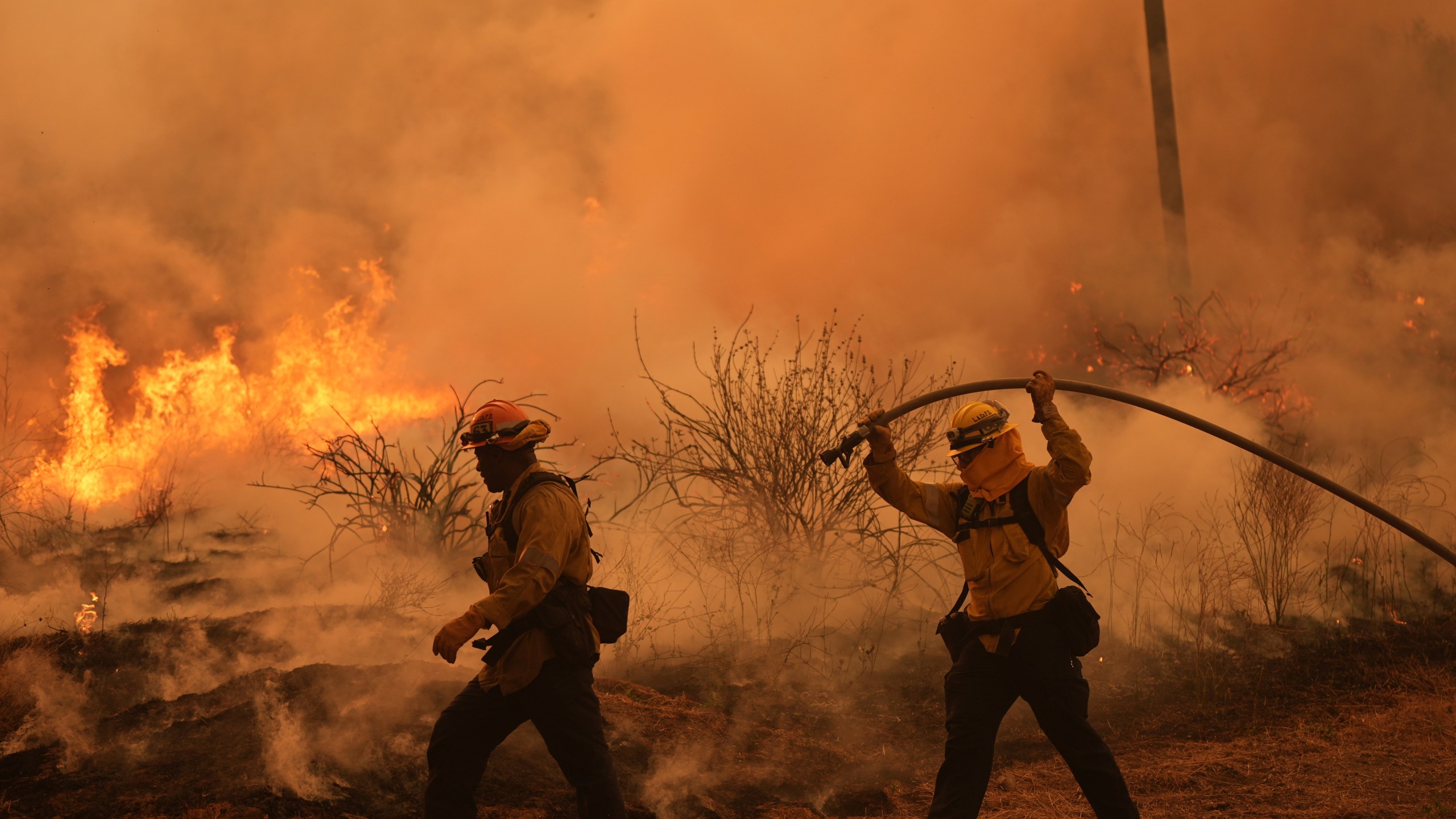 firefighters work to battle a fire