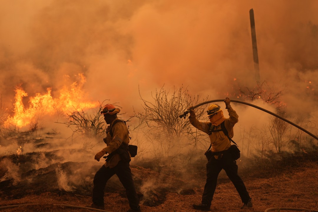 firefighters work to battle a fire