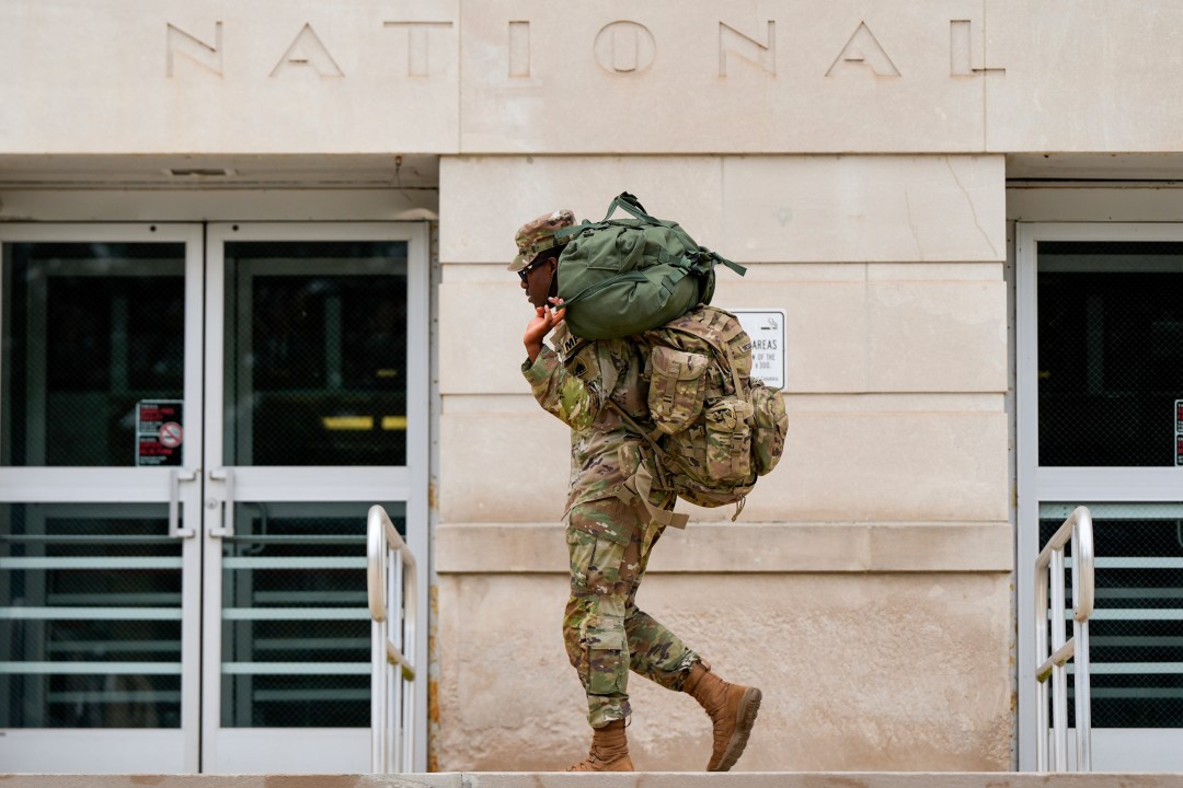 District of Columbia National Guard walks carrying backpacks