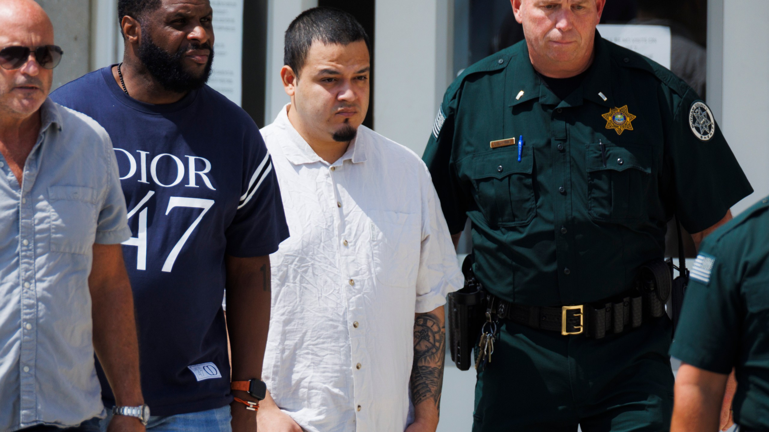 Kilmar Abrego Garcia walks with law enforcement