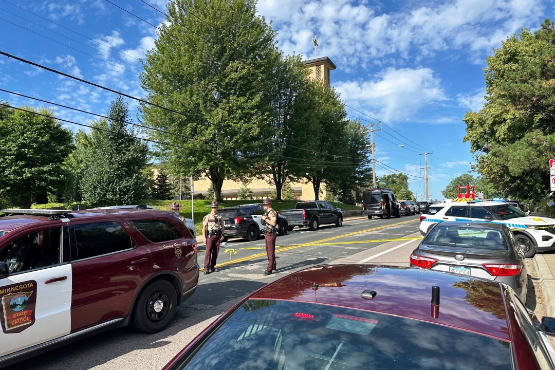 Law enforcement officers outside the Annunciation Church's school.
