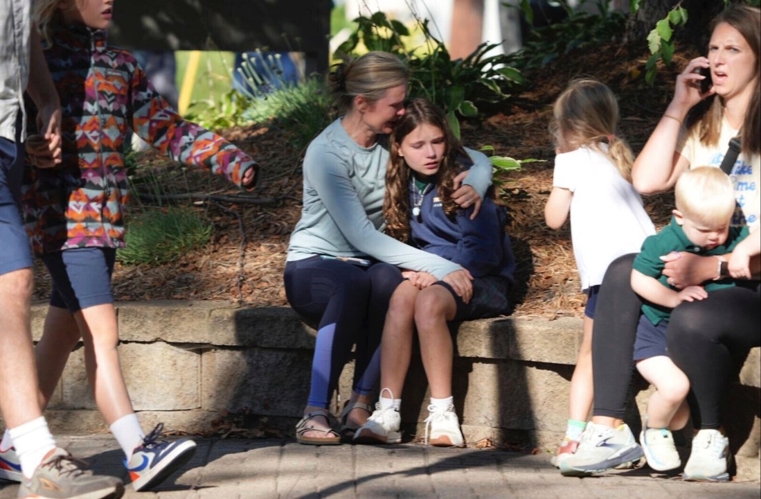 Parents and students sit outside of Annunciation Catholic School in Minneapolis, Minnesota.