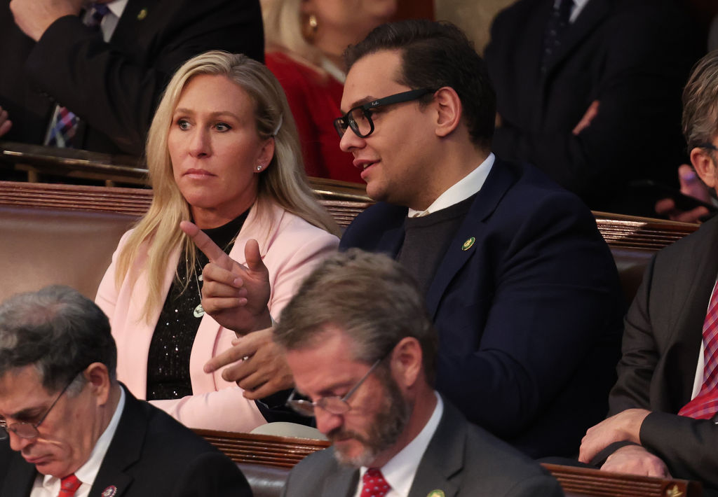 Marjorie Taylor Green and George Santos speak during a House meeting