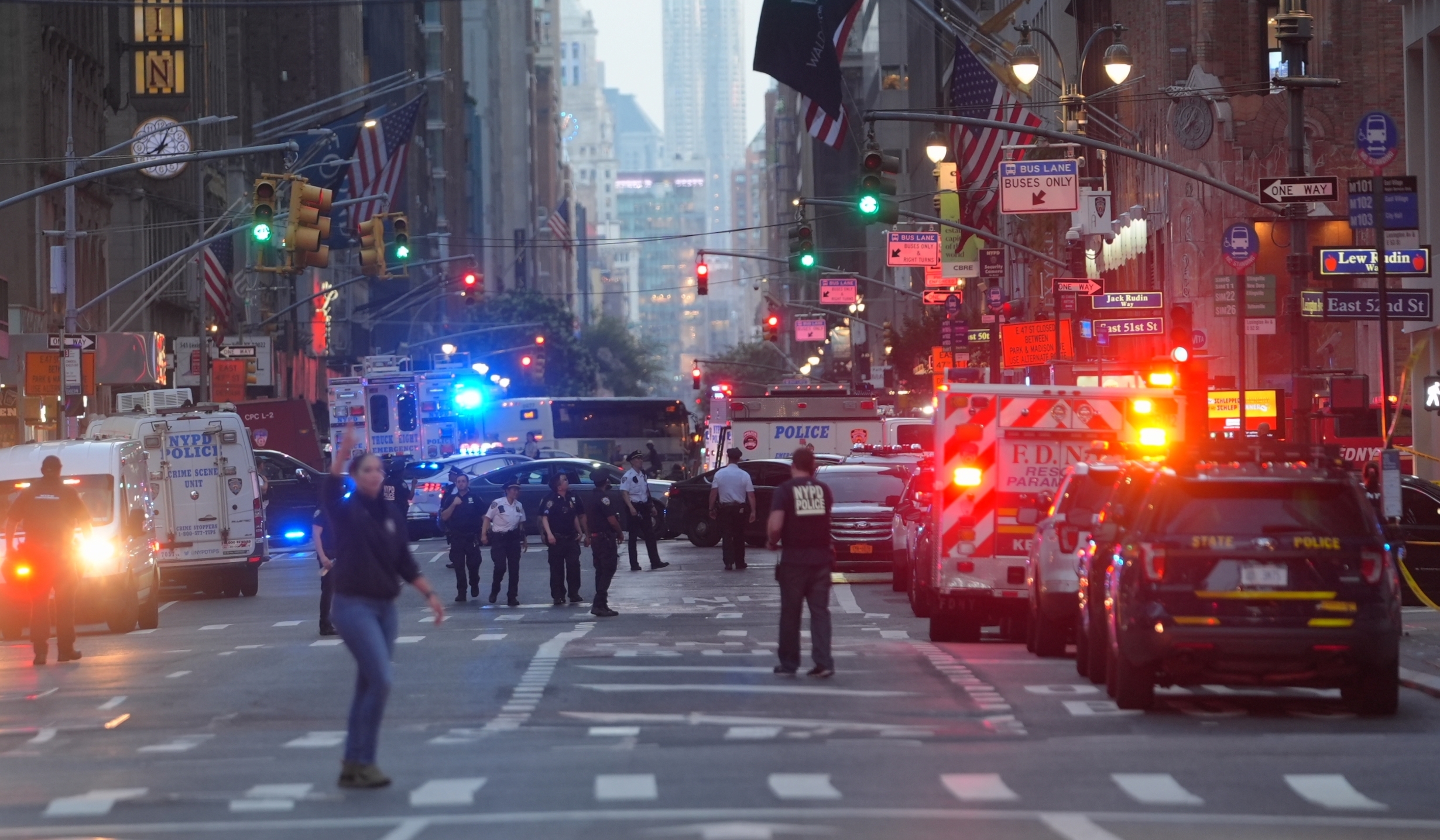 officers and emergency vehicles with lights on in the streets of Manhattan