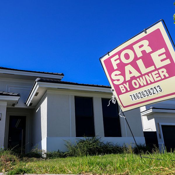 a FOR SALE sign in a yard