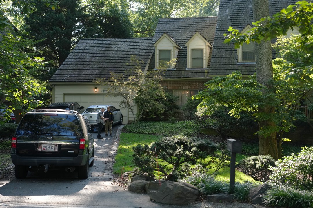 FBI agents work outside the home of John Bolton