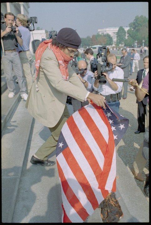 A 1989 photo shows "Dred" Scott W. Tyler, a Chicago artist burn an American flag on the steps of the U.S. Capitol as part of a protest