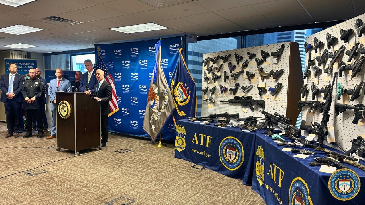 Weapons seized by ATF are displayed during press conference