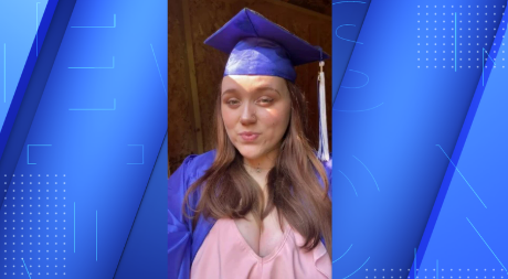 Kylee Monteiro smiles for a photo wearing cap and gown