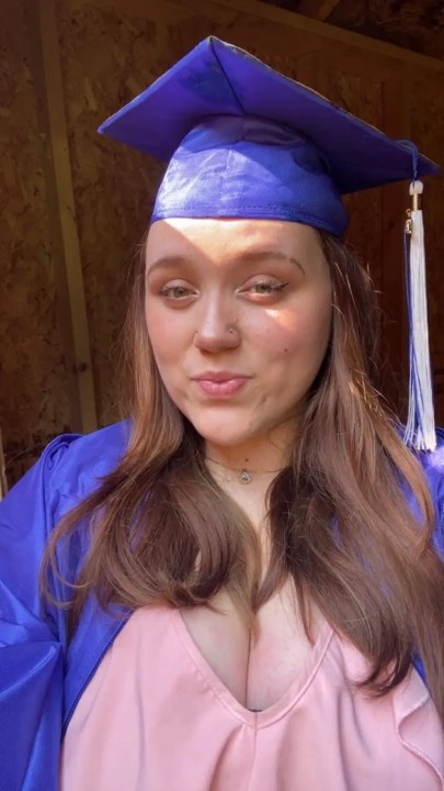 Kylee Monteiro smiling while wearing a cap and gown