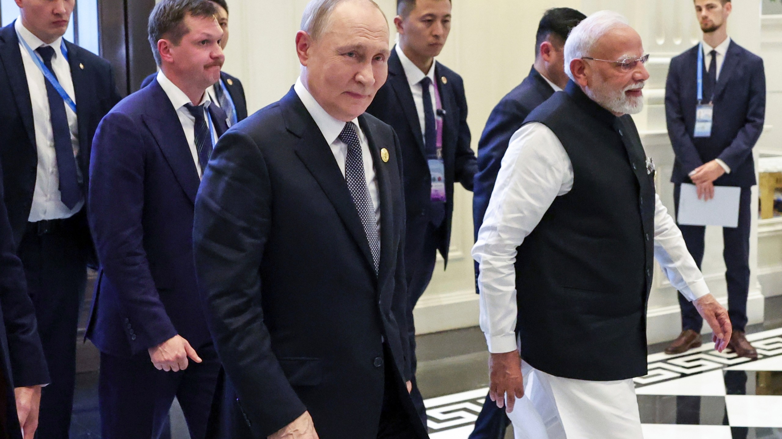 Russian President Vladimir Putin, center, and Indian Prime Minister Narendra Modi, right, enter a hall for their meeting on the sidelines of the Shanghai Cooperation Organization (SCO) summit in Tianjin, China, Monday, Sept. 1, 2025. (Roman Naumov, Sputnik, Kremlin Pool Photo via AP)