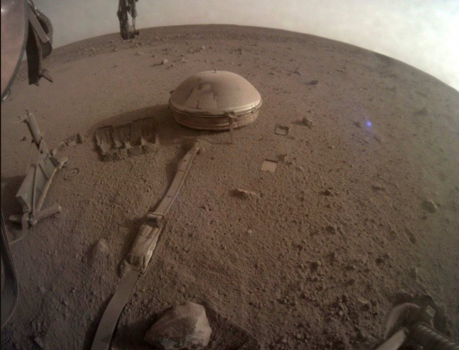 This image provided by NASA shows the seismometer on the surface of Mars attached to NASA's InSight lander, which registered more than 1,300 marsquakes before shutting down in 2022. This is one of the lander's last photos. (NASA via AP)