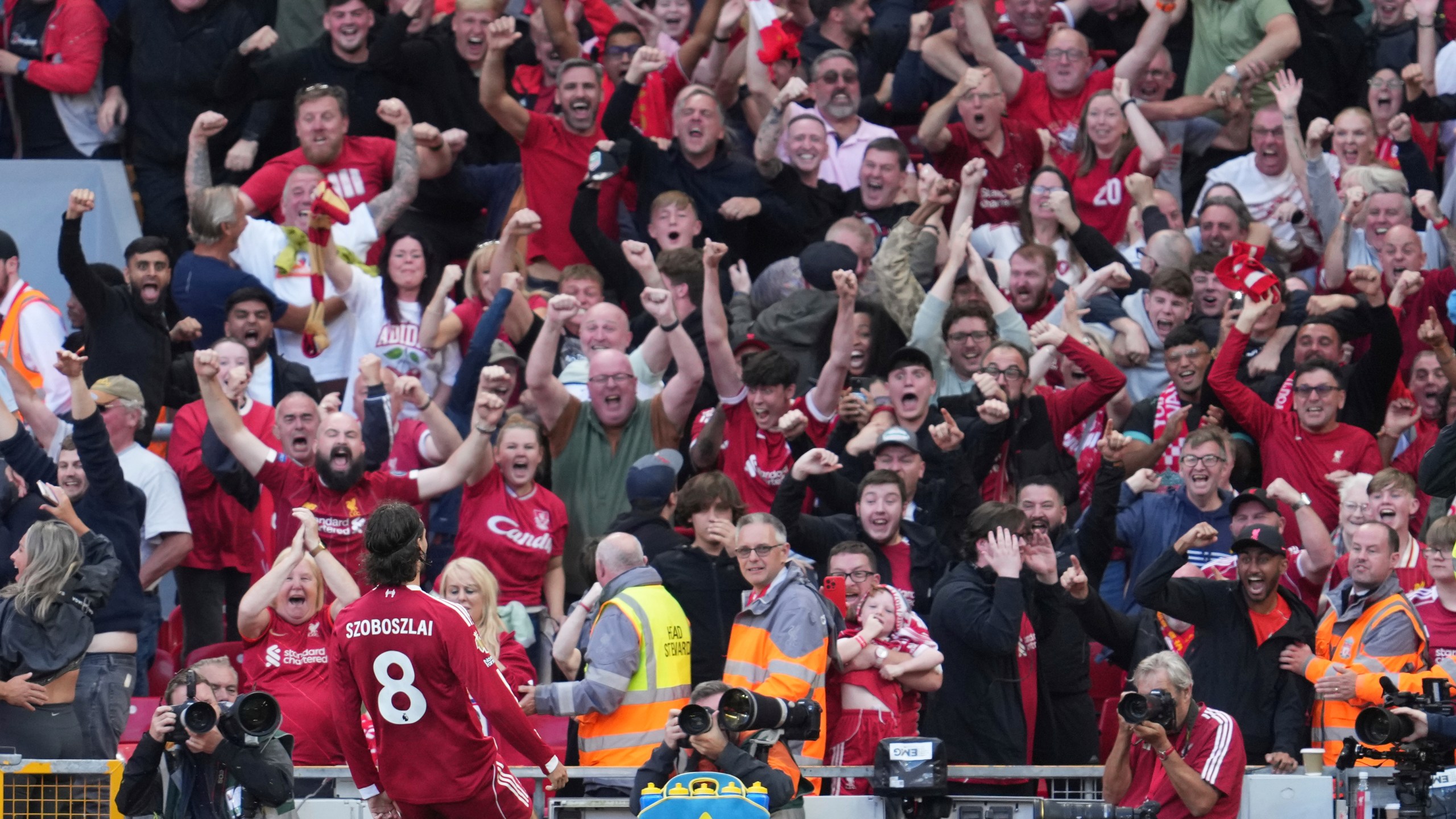 Liverpool's Dominik Szoboszlai celebrates after scoring his sides first goal during the English Premier League soccer match between FC Liverpool and FC Arsenal in Liverpool, England, Sunday, Aug. 31, 2025. (AP Photo/Jon Super)