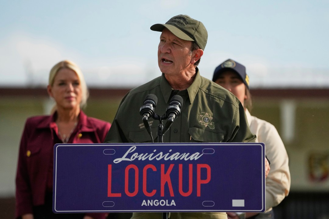 FILE - Louisiana Gov. Jeff Landry speaks to reporters outside "Camp 57," a facility to house immigration detainees at the Louisiana State Penitentiary in Angola, La., Wednesday, with Attorney General Pam Bondi, , left, and ICE Deputy Director Madison Sheahan, partially visible right, Sept. 3, 2025. (AP Photo/Gerald Herbert, File)