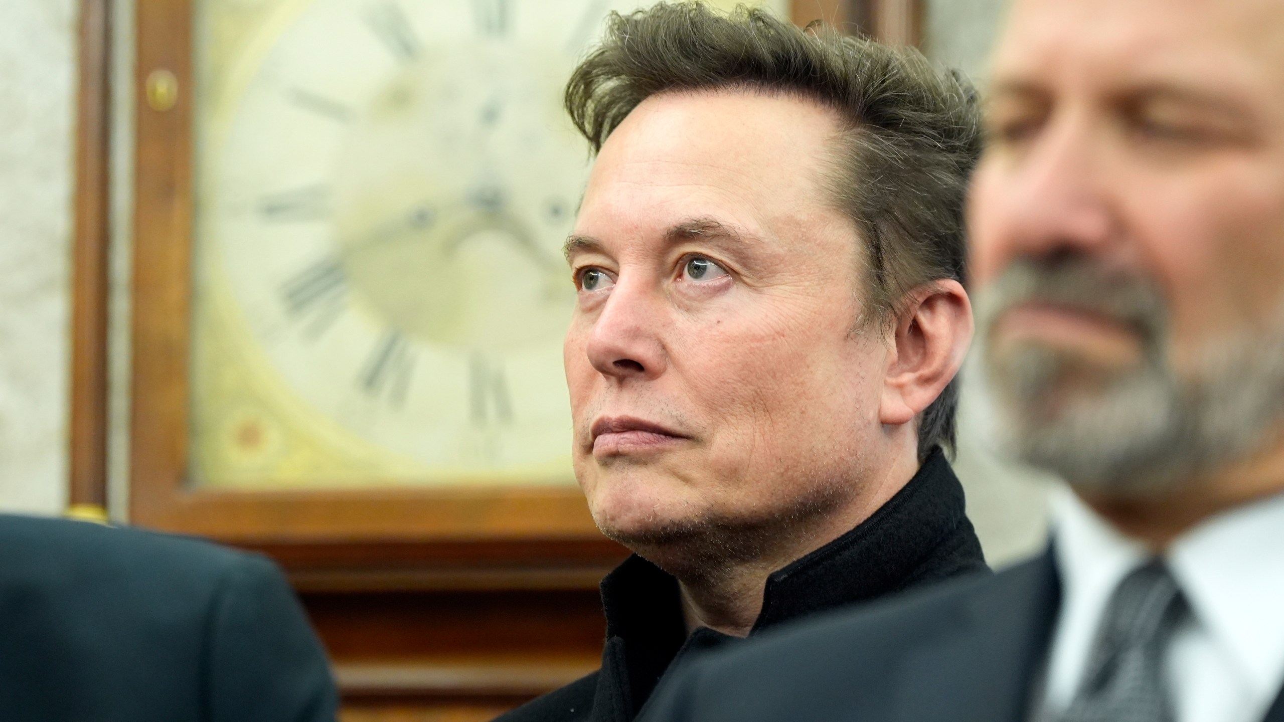 Musk listens during a meeting at the WHite House