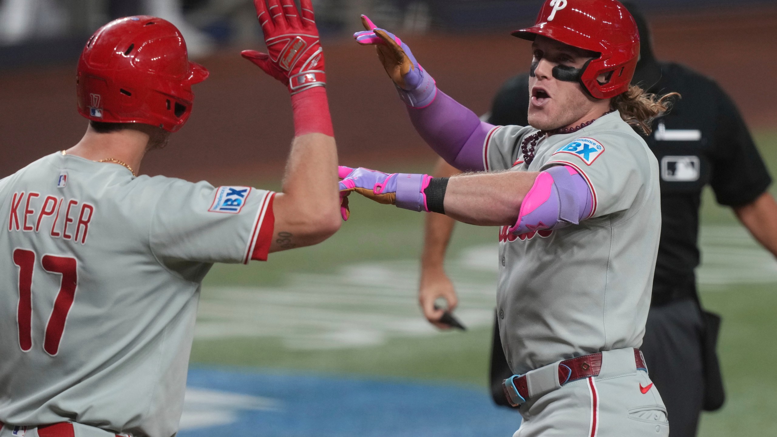 Philadelphia Phillies' Harrison Bader, right, celebrates with Max Kepler (17) after hitting a home run during the fourth inning of a baseball game against the Miami Marlins Friday, Sept. 5, 2025, in Miami. (AP Photo/Marta Lavandier)