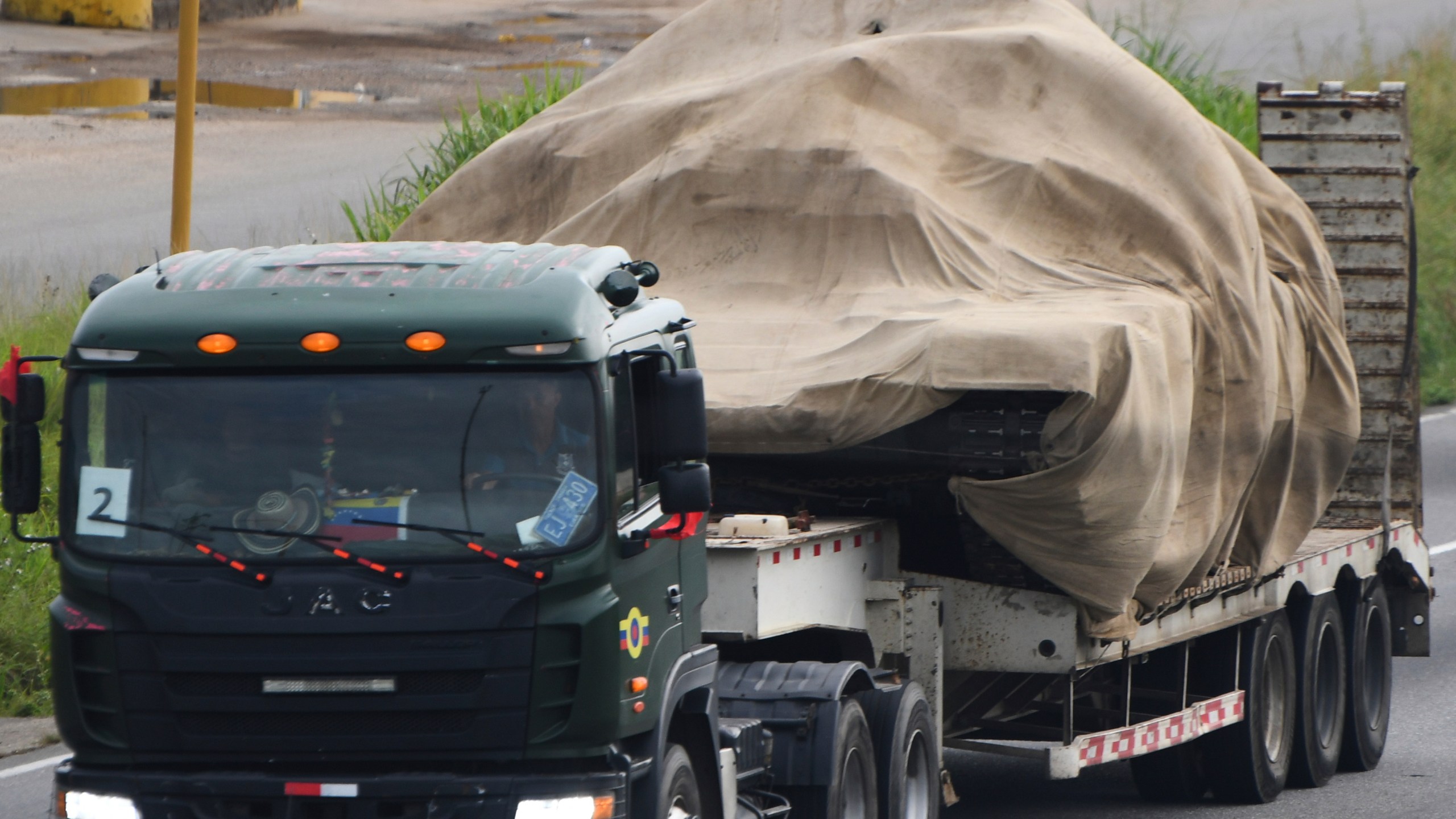 Trucks transport tanks east from Valencia, Venezuela, Wednesday, Aug. 27, 2025, after the government announced a military mobilization following the U.S. deployment of warships off Venezuela. (AP Photo/Jacinto Oliveros)