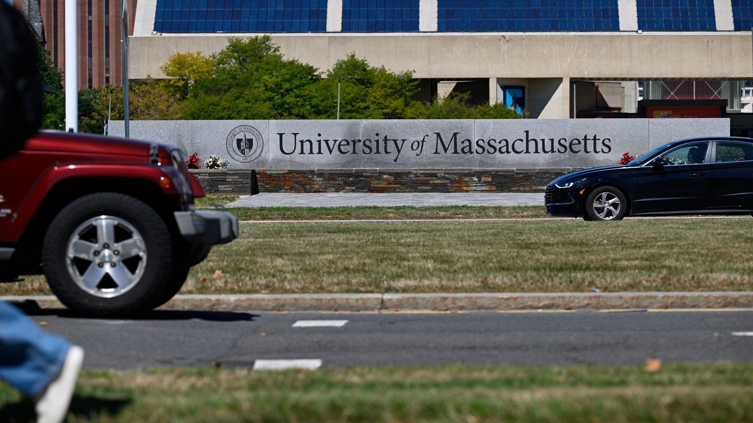 In this Sept. 3, 2025 photo, Cars pass by the University of Massachusetts, in Amherst, Mass. (AP Photo/Jessica Hill)
