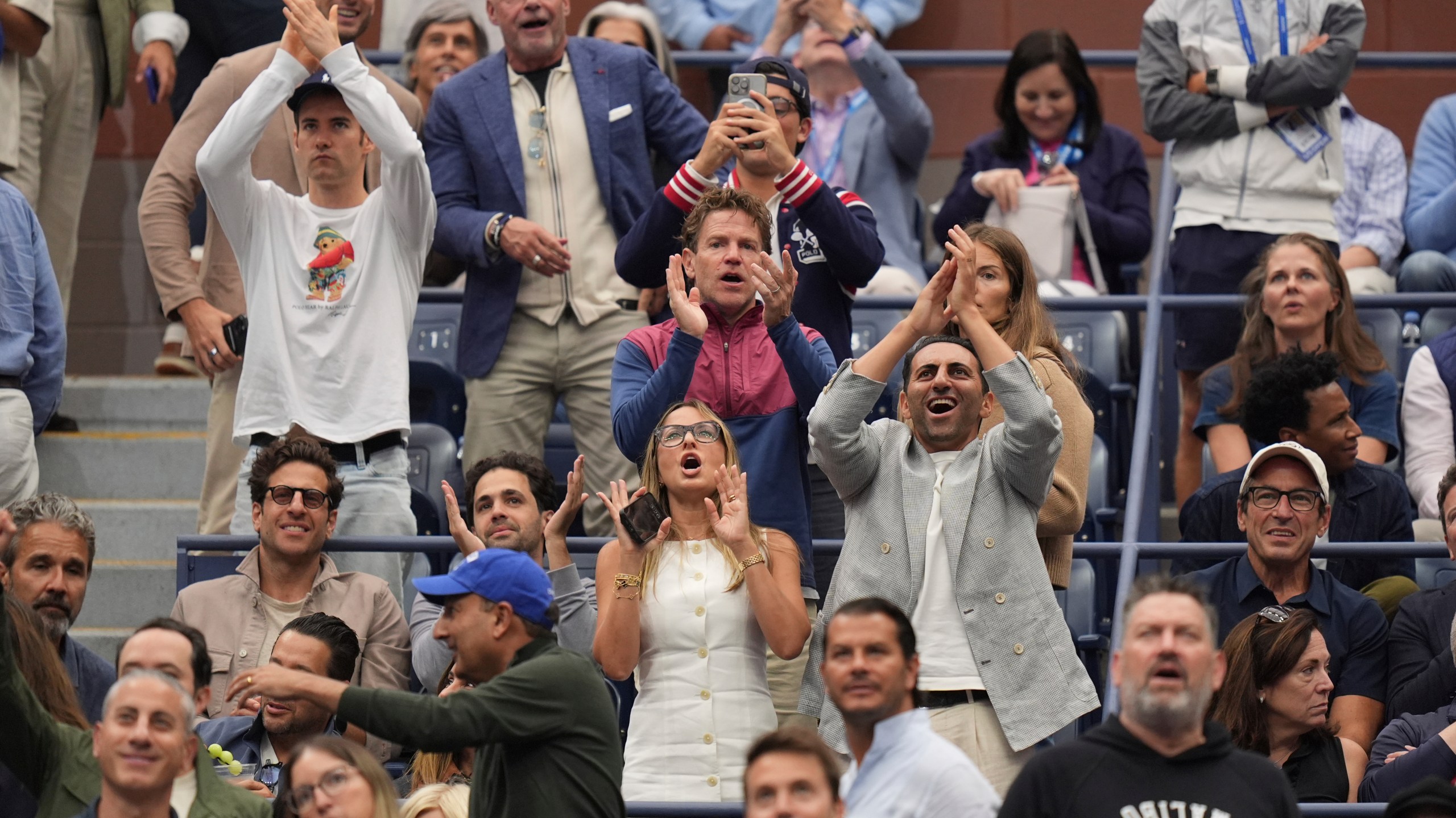 Fans react to President Donald Trump during the men's singles final of the U.S. Open tennis championships, Sunday, Sept. 7, 2025, in New York. (AP Photo/Seth Wenig)