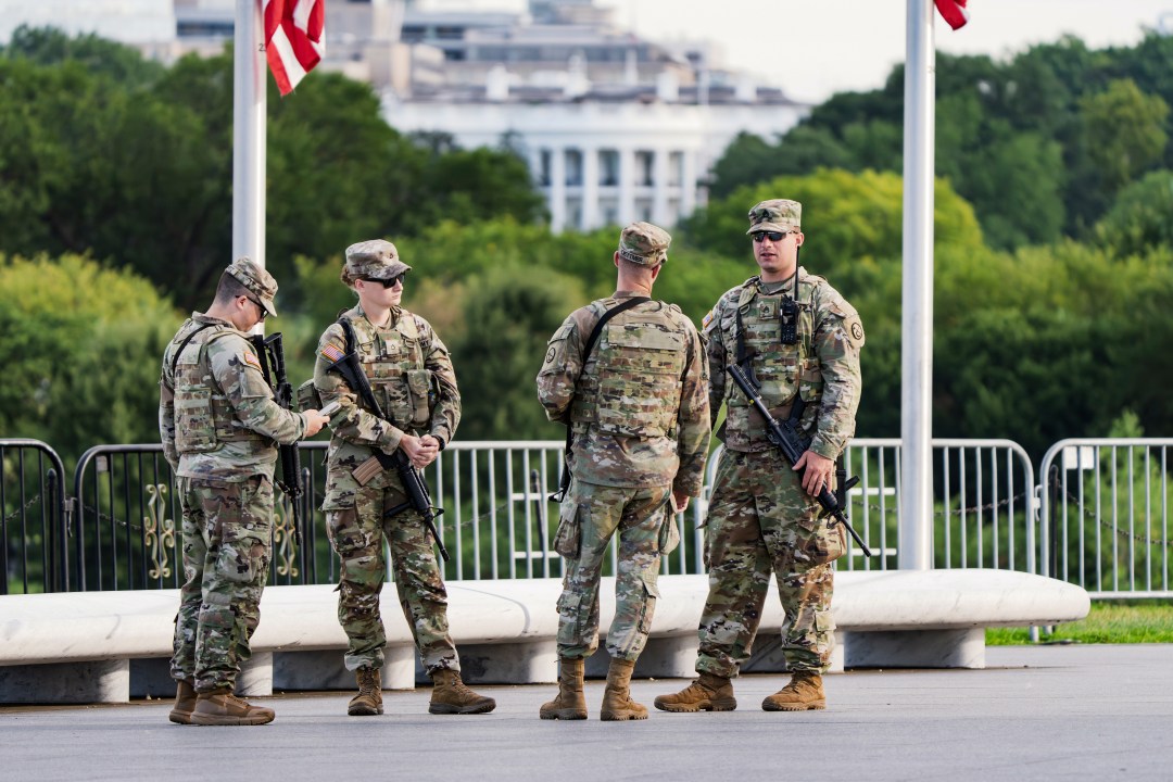 FILE - With the White House in the distance, National Guard troops patrol the Mall as part of President Donald Trump's order to impose federal law enforcement in the nation's capital, in Washington, Aug. 28, 2025. (AP Photo/J. Scott Applewhite, File)