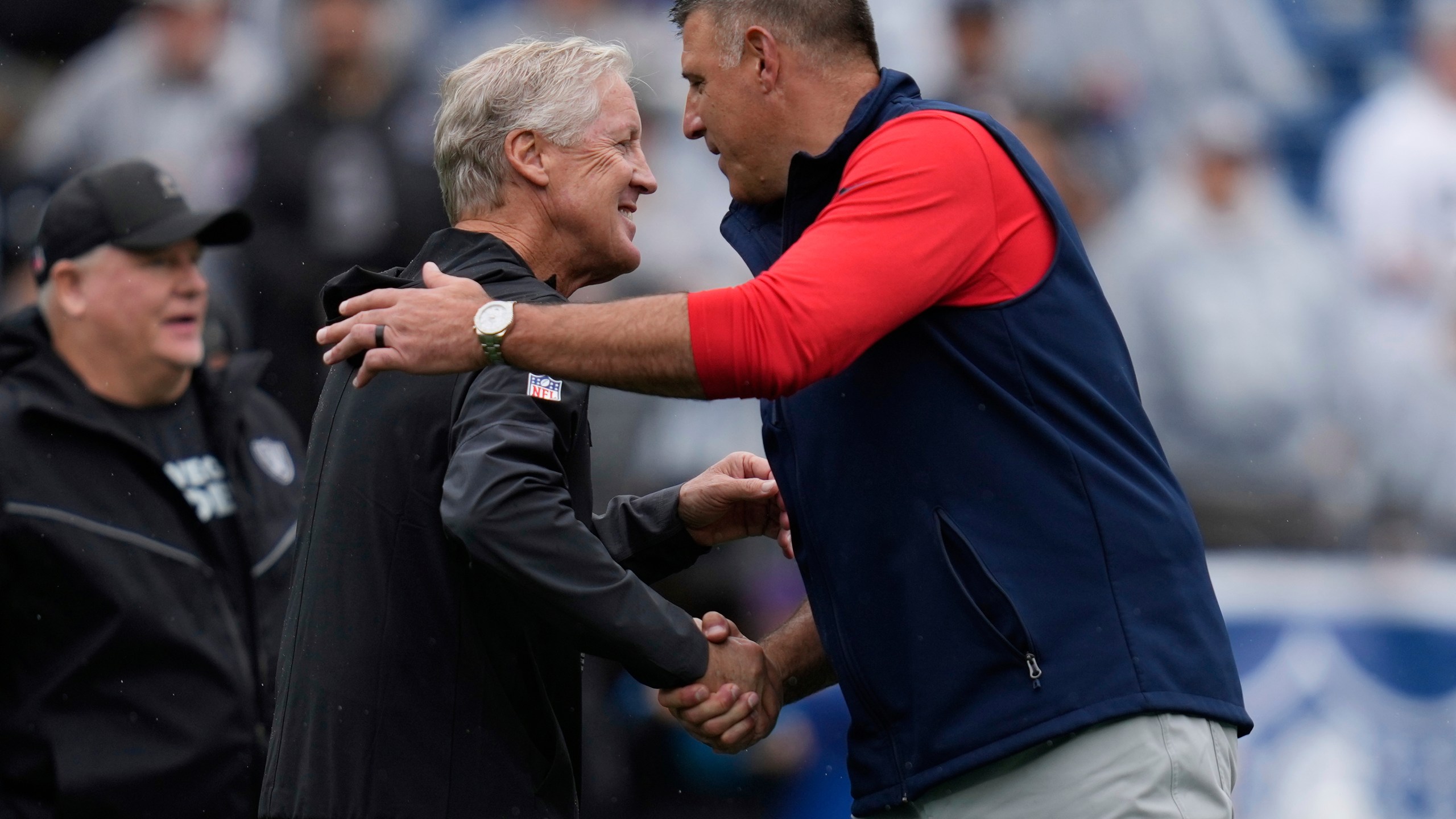 Las Vegas Raiders head coach Pete Carroll, left, and New England Patriots head coach Mike Vrabel greet each other before an NFL football game, Sunday, Sept. 7, 2025, in Foxborough, Mass. (AP Photo/Charles Krupa)