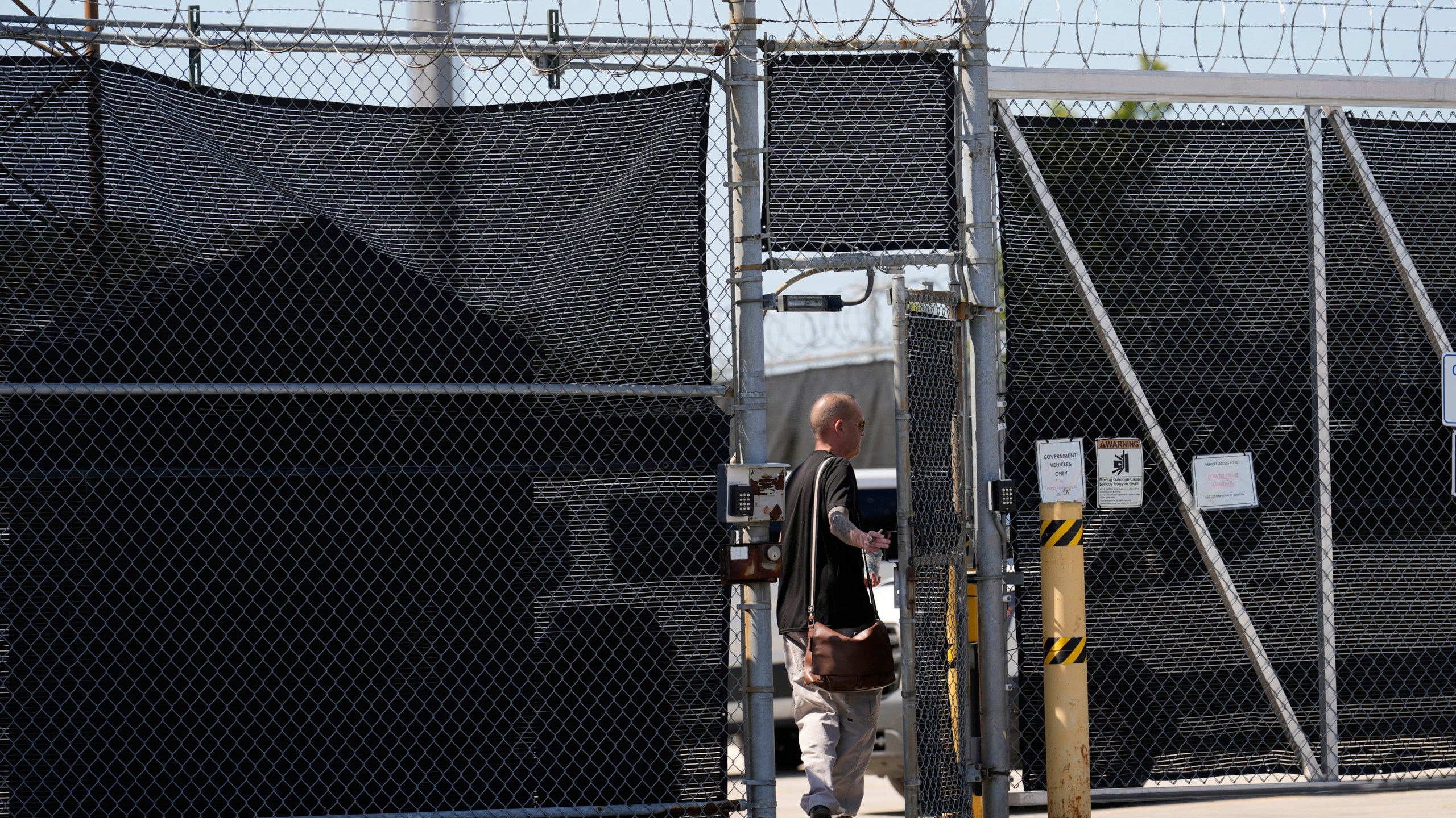 A person walks in to the entrance adjacent to an immigration processing center Monday, Sept. 8, 2025, in Broadview, Ill., a suburb of Chicago. (AP Photo/Carolyn Kaster)