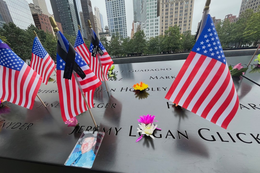Flags and flowers are placed at the National September 11 Memorial