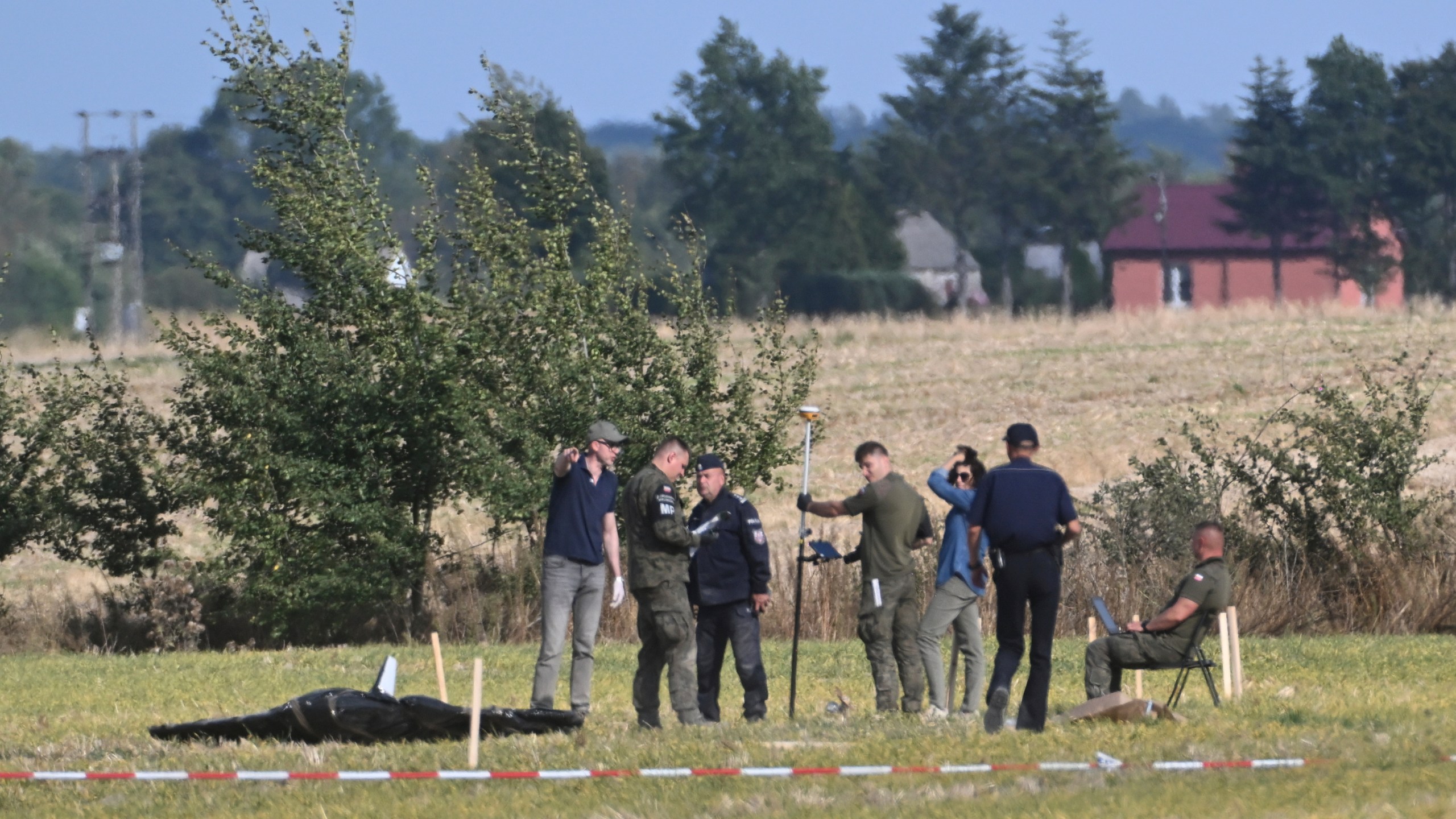 Police and Military Police secure parts of a damaged UAV