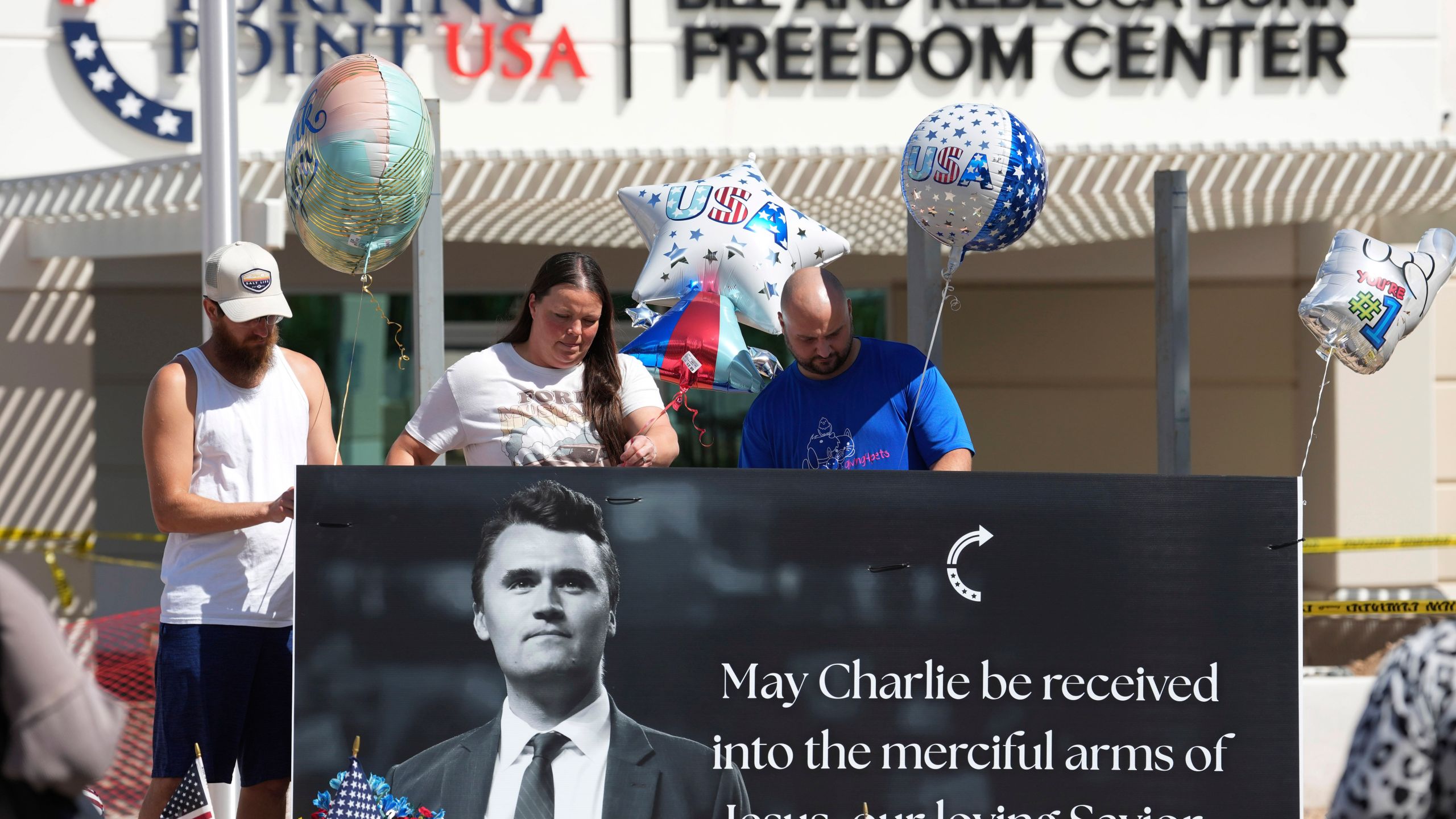 Well-wishers add balloons to a makeshift memorial set up at Turning Point USA headquarters after the shooting death at a Utah college on Wednesday of Charlie Kirk, the 31-year-old founder and CEO of the organization, Thursday, Sept. 11, 2025, in Phoenix. (AP Photo/Ross D. Franklin)