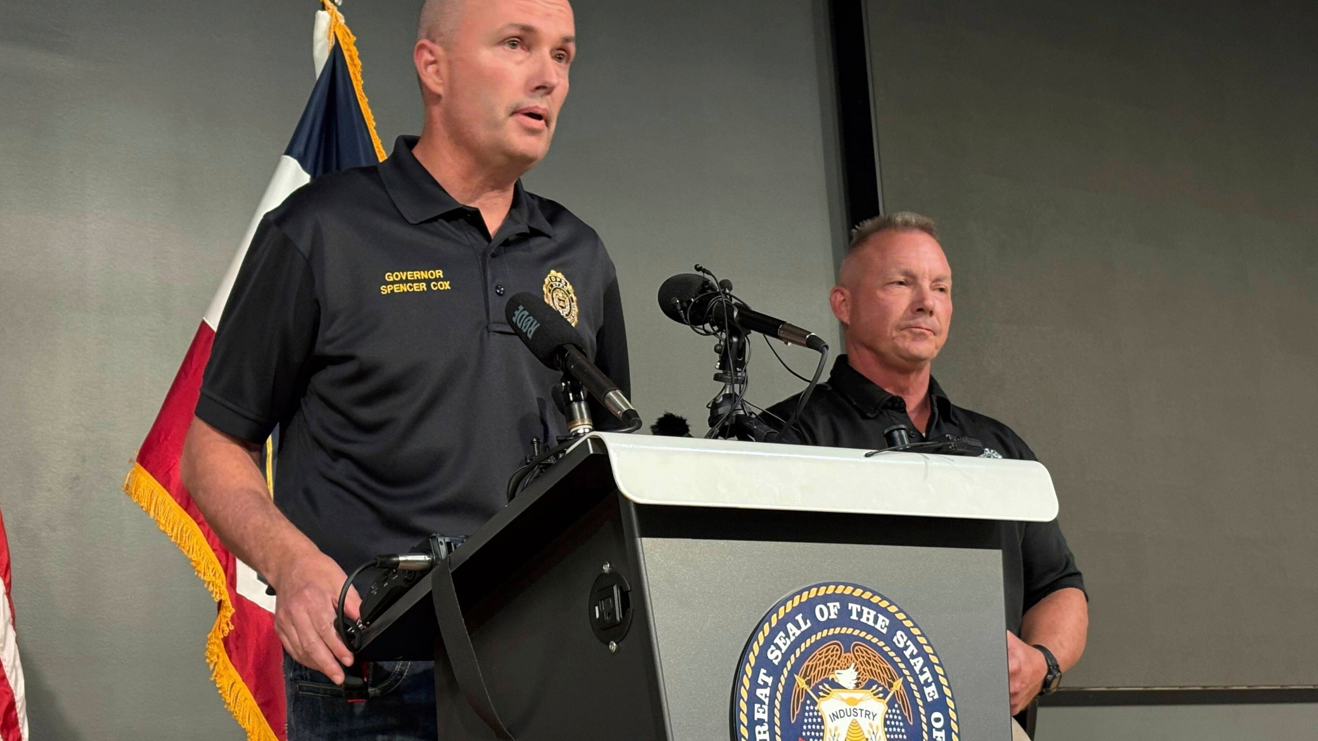 Utah Gov. Spencer Cox, left, speaks with Utah Valley University Chief of Police Jeff Long, right, at a press conference at the Keller Building on the Utah Valley University campus after Charlie Kirk was shot and died during Turning Point's visit to the university, Wednesday, Sept. 10, 2025, in Orem, Utah. (AP Photo/Hannah Schoenbaum)
