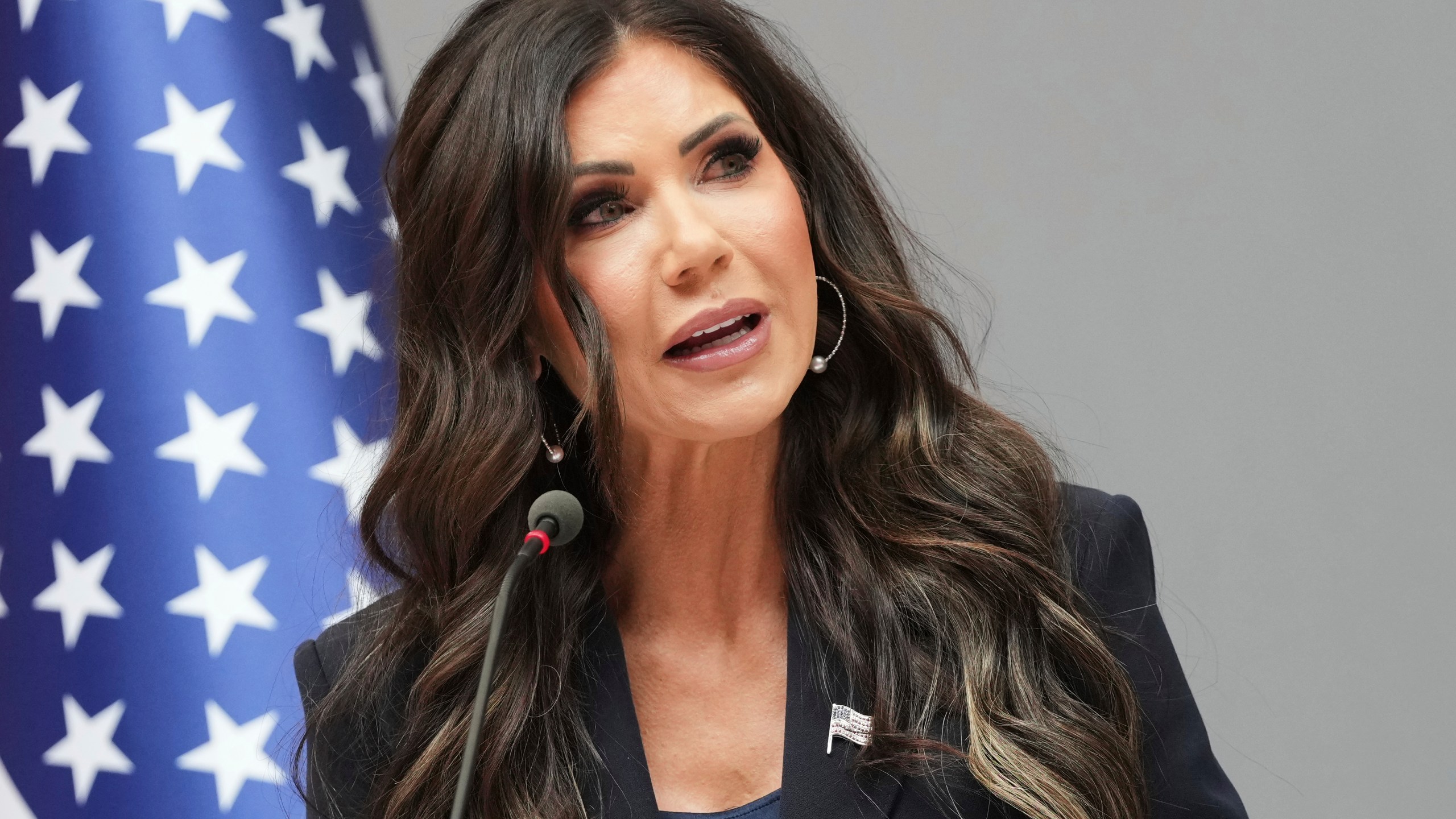 Kristi Noem speaks from a podium