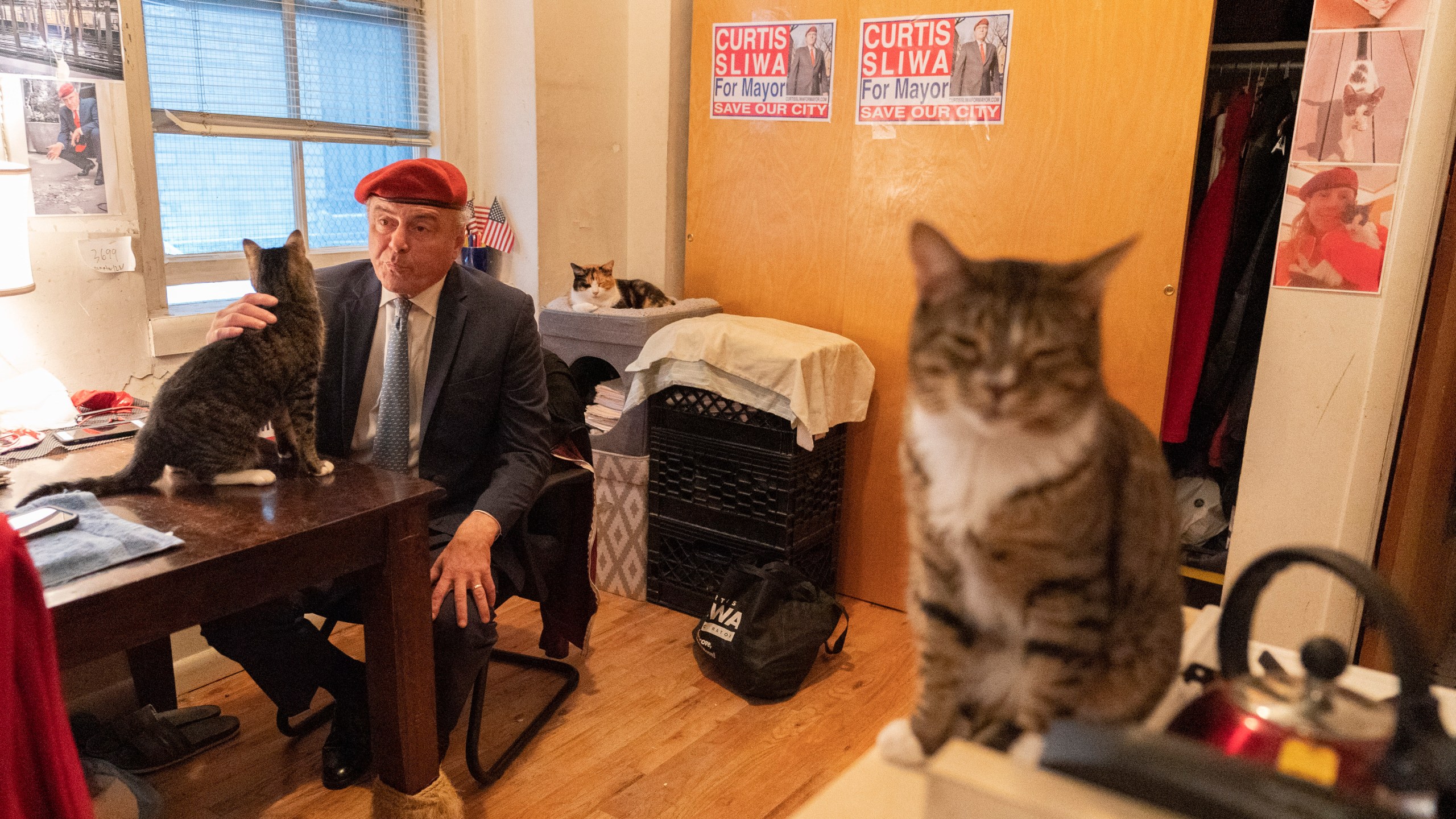 FILE - New York City Republican mayoral candidate Curtis Sliwa pets one of his cats as he speaks during an interview with The Associated Press in his apartment, Tuesday, Oct. 12, 2021, in New York. (AP Photo/Mary Altaffer, file)