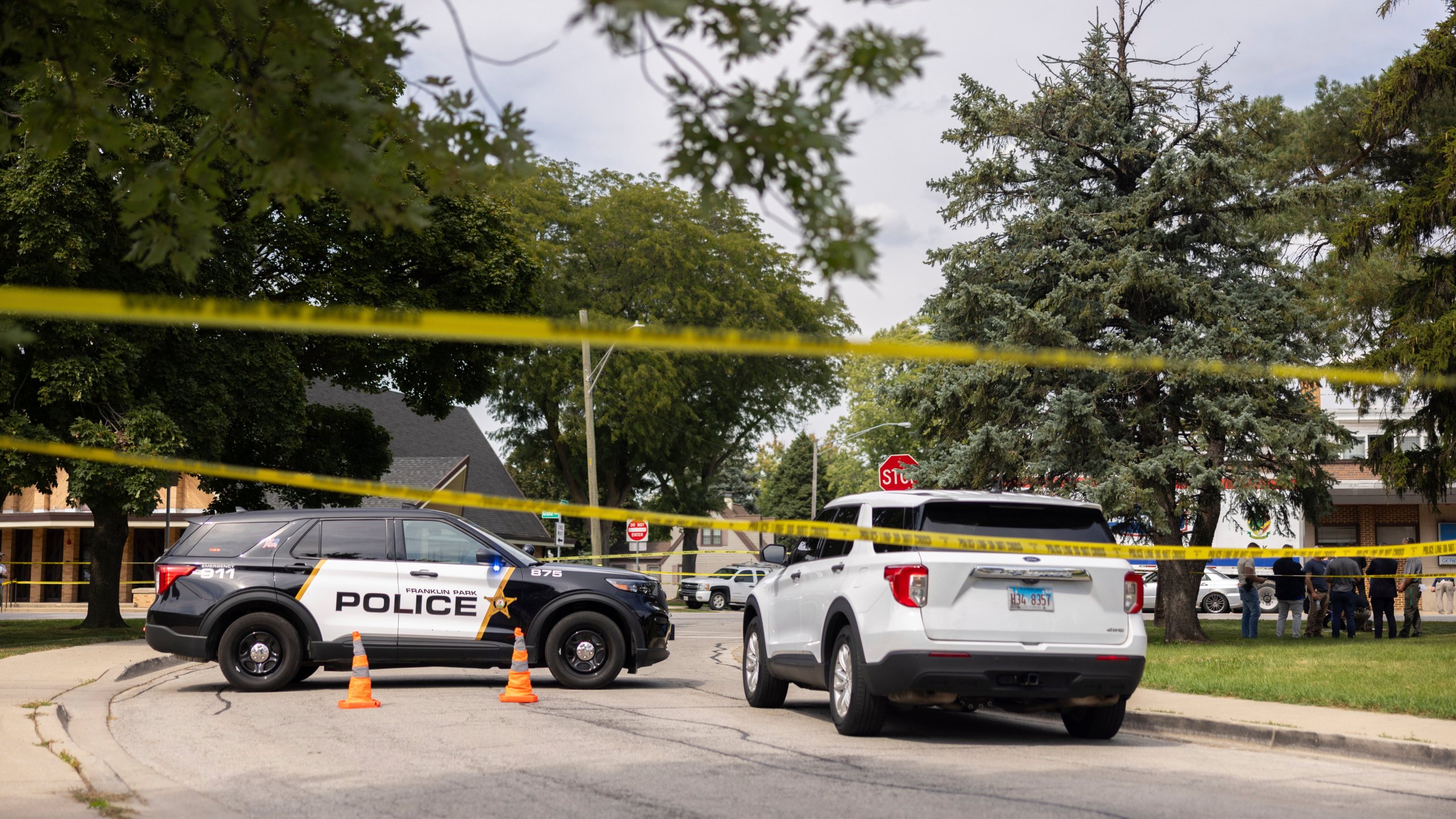 Law enforcement personnel investigate after the Department of Homeland Security said an Immigration and Customs Enforcement agent fatally shot a man in the Franklin Park suburb of Chicago on Friday, Sept. 12, 2025. (Candace Dane Chambers/Chicago Sun-Times via AP)