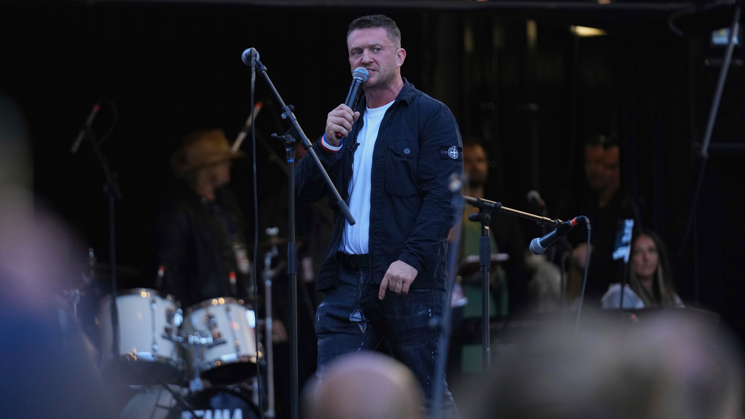 Tommy Robinson speaks during the Unite the Kingdom march and rally near Westminster, London, Saturday Sept. 13, 2025. (AP Photo/Joanna Chan)