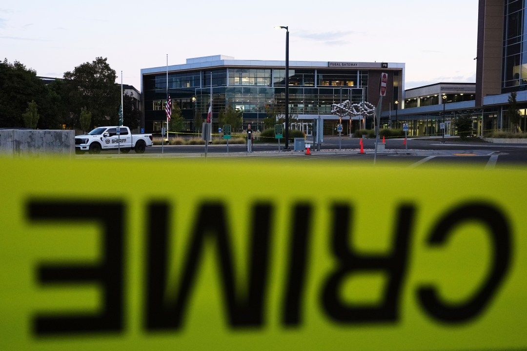 Crime scene tape surrounds Utah Valley University after Turning Point USA CEO and co-founder Charlie Kirk was shot and killed , Saturday, Sept. 13, 2025, in Orem, Utah. (AP Photo/Lindsey Wasson)