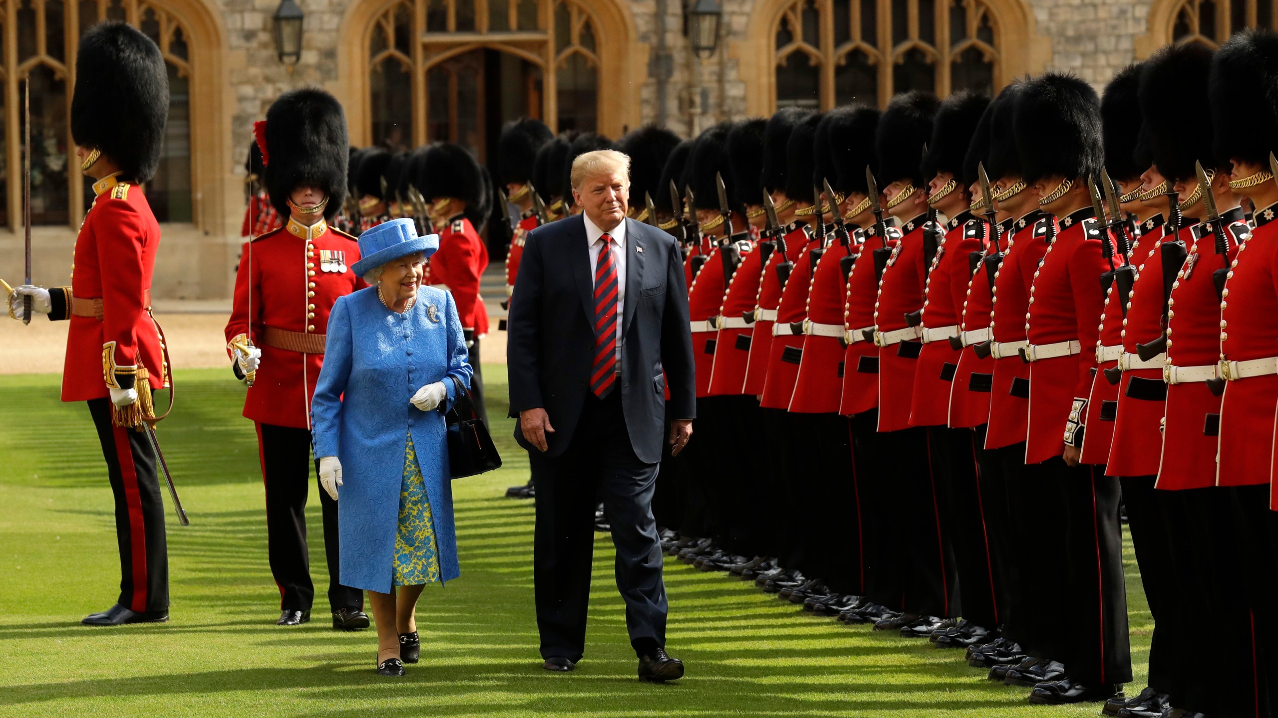 FILE - U.S. President Donald Trump and Britain's Queen Elizabeth II inspect a Guard of Honour, formed of the Coldstream Guards at Windsor Castle in Windsor, England, July 13, 2018.(AP Photo/Matt Dunham, Pool, File)