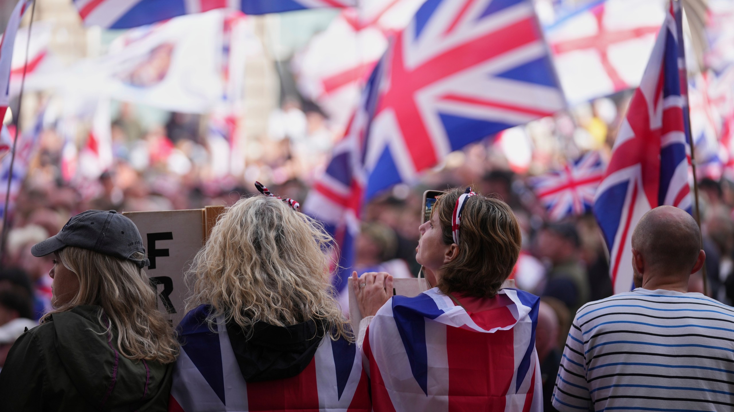 People demonstrate during the Tommy Robinson-led Unite the Kingdom march and rally, in London Saturday Sept. 13, 2025. (AP Photo/Joanna Chan)