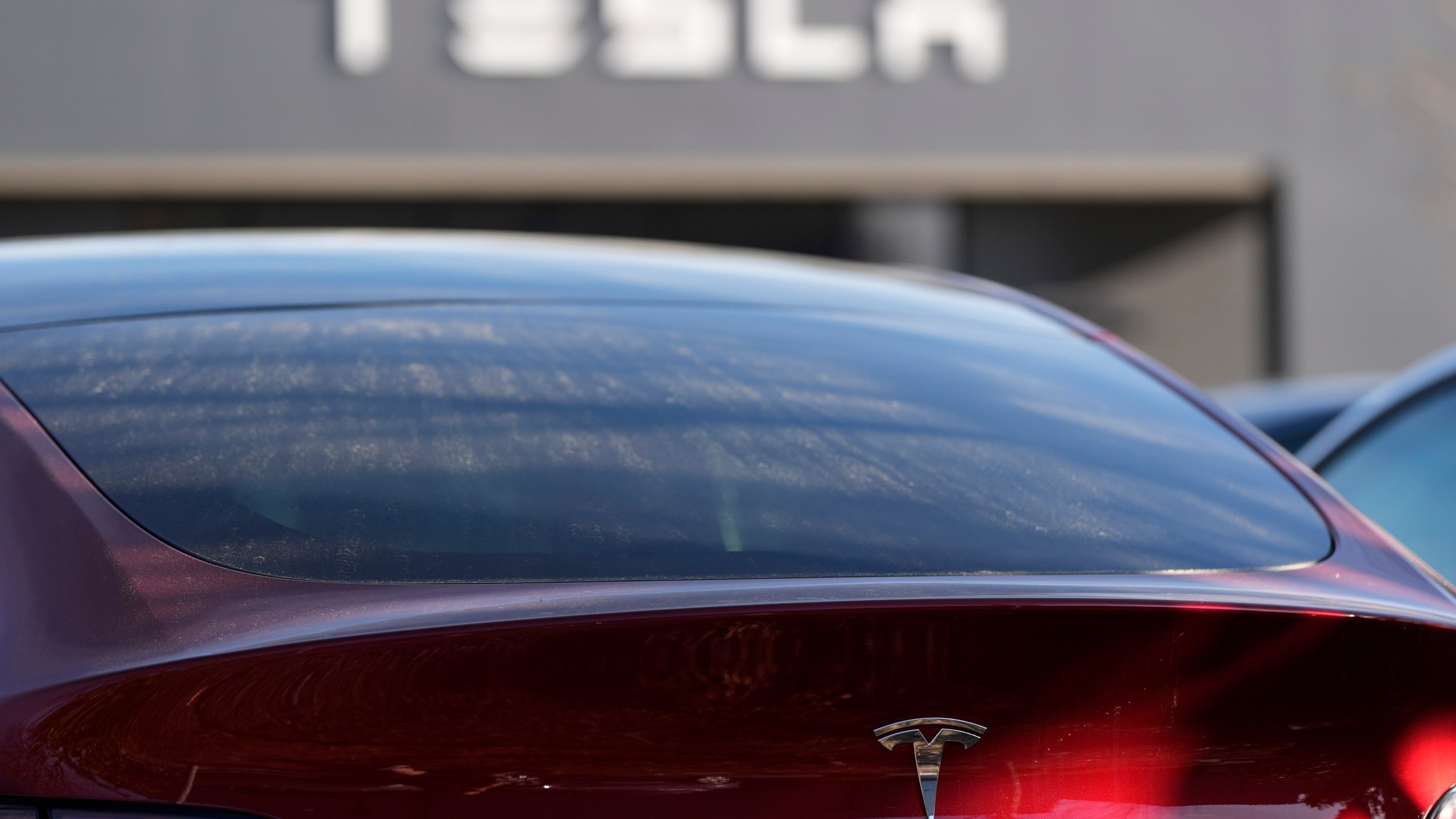 FILE - A Tesla model Y and other Telsla vehicles sit at a dealership, Wednesday, March 19, 2025, in Kennesaw, Ga. (AP Photo/Mike Stewart, File)