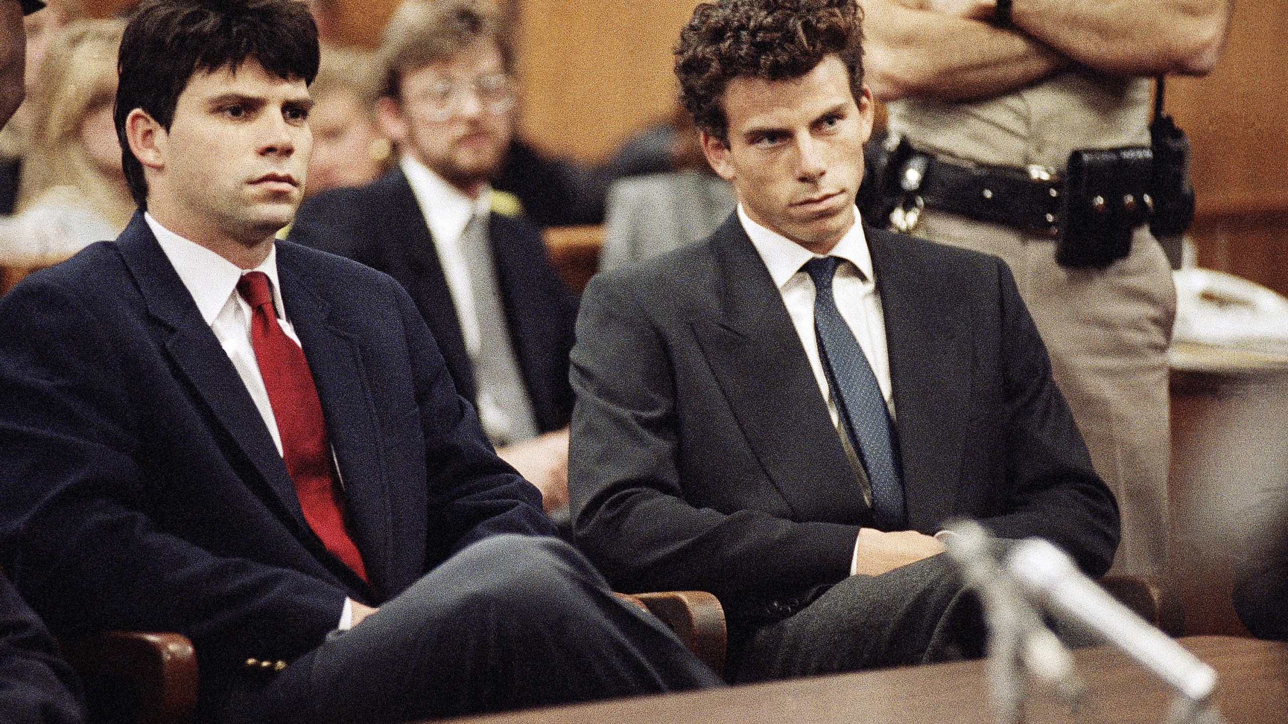 FILE - Lyle, left, and Erik Menendez sit in Beverly Hills Municipal Court where their attorneys delayed making pleas on their behalf in Beverly Hills, Calif., March 12, 1990. (AP Photo/Nick Ut, File)