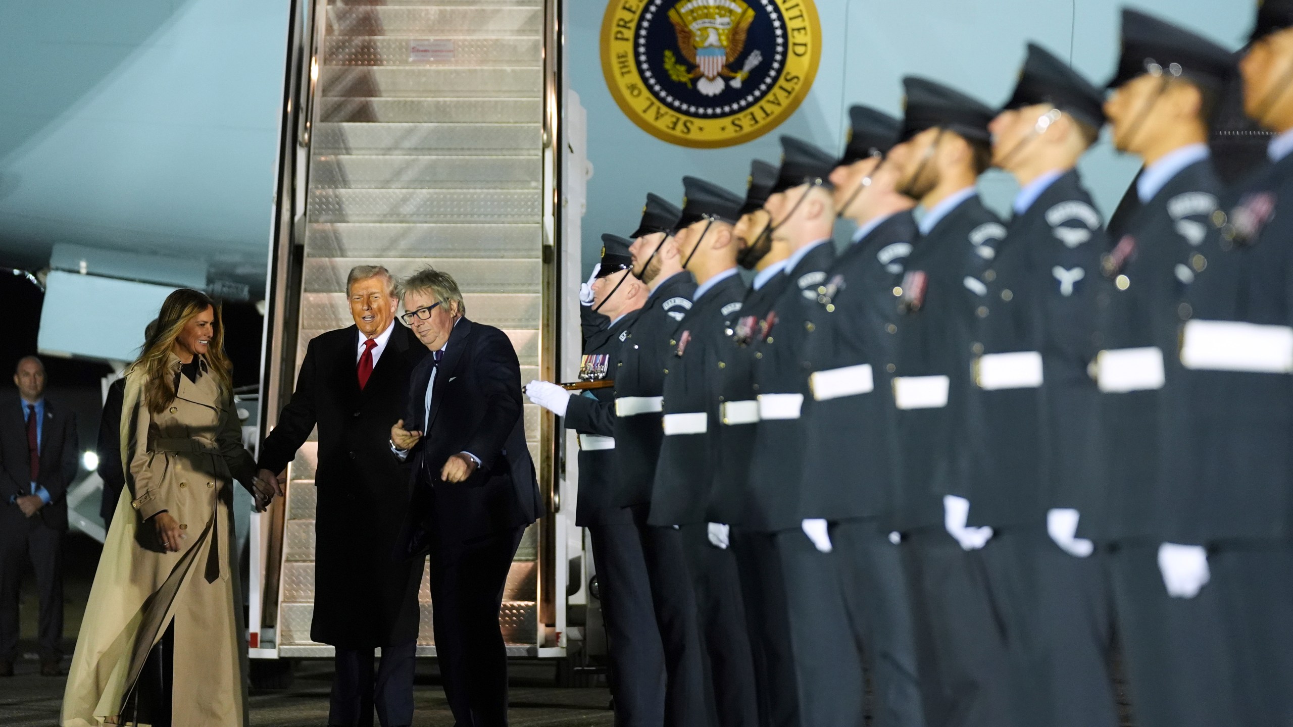 President Donald Trump and first lady Melania Trump are greeted by The Viscount Hood, Lord-in-Waiting, center, right, as they arrive at Stansted Airport near London, Tuesday, Sept. 16, 2025. (AP Photo/Evan Vucci)