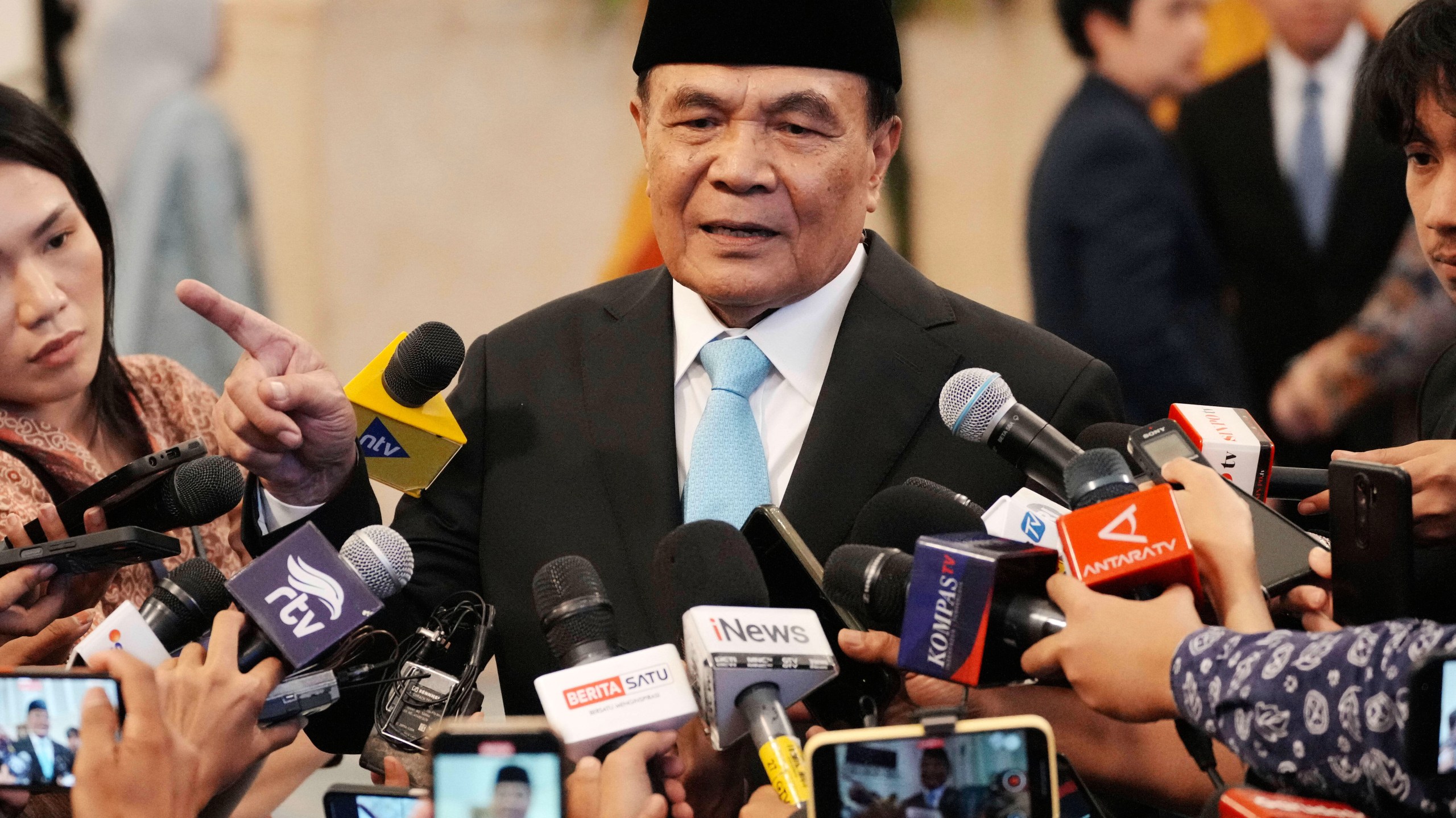 Indonesia's newly-appointed Coordinating Minister for Political and Security Affairs Djamari Chaniago talks to journalists after swearing-in ceremony at the presidential palace in Jakarta, Indonesia , Wednesday, Sept. 17, 2025. (AP Photo/Achmad Ibrahim)