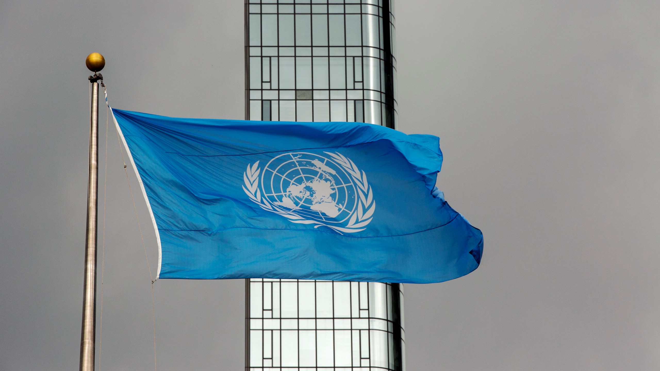 FILE - The UN flag flies on a stormy day at the United Nations during the United Nations General Assembly, Sept. 22, 2022. (AP Photo/Ted Shaffrey, File)