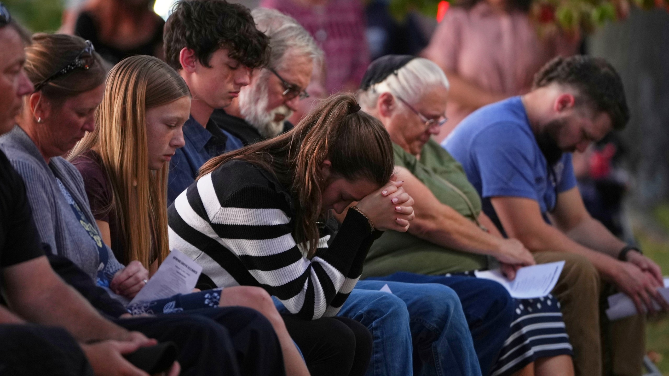 Attendees react during a vigil at Spring Grove Alliance church Thursday, Sept. 18, 2025, in Spring Grove, Pa., after multiple police officers were shot and killed. (AP Photo/Matt Slocum)