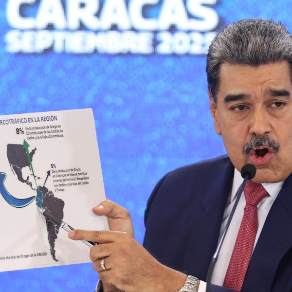 Venezuelan President Nicolas Maduro points at a map of the Americas during a press conference in Caracas, Venezuela, Monday, Sept 15, 2025. (AP Photo/Jesus Vargas)