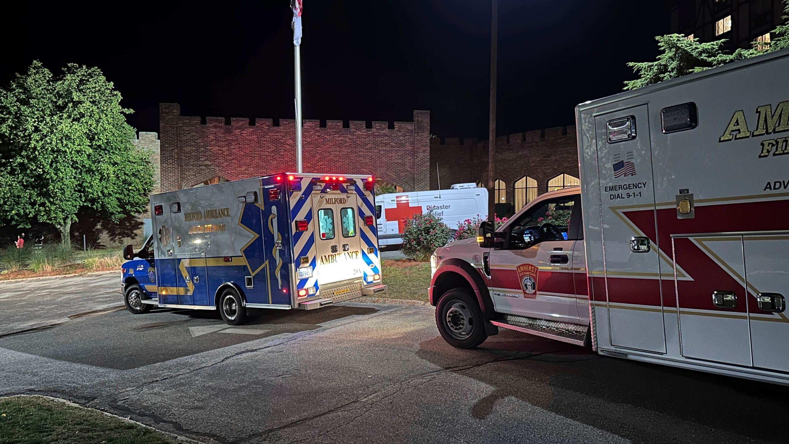 Ambulances are parked outside a hotel that is acting as a reunification center after a shooting at a country club in Nashua, New Hampshire, Saturday, Sept. 20, 2025. (AP Photo/Michael Casey)